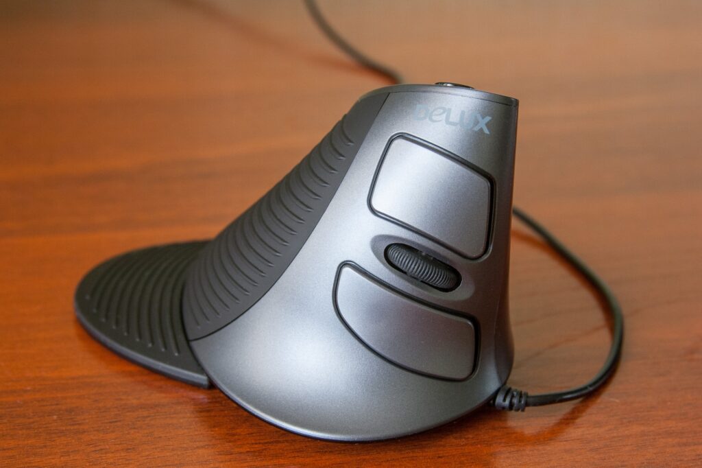 A vertical mouse on a UK home office desk - the ergonomic switch many remote workers are making in 2026