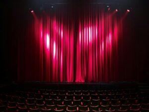 Empty theatre auditorium with red velvet curtains and seating, illustrating West End Summer 2026 line-up.