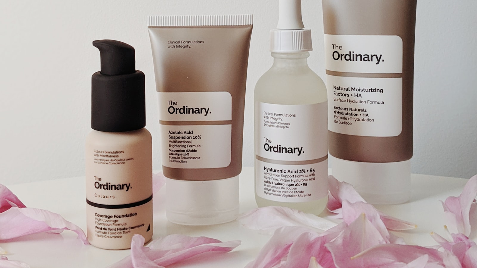 Skincare bottles lined up on a shelf, including over-the-counter acid treatments