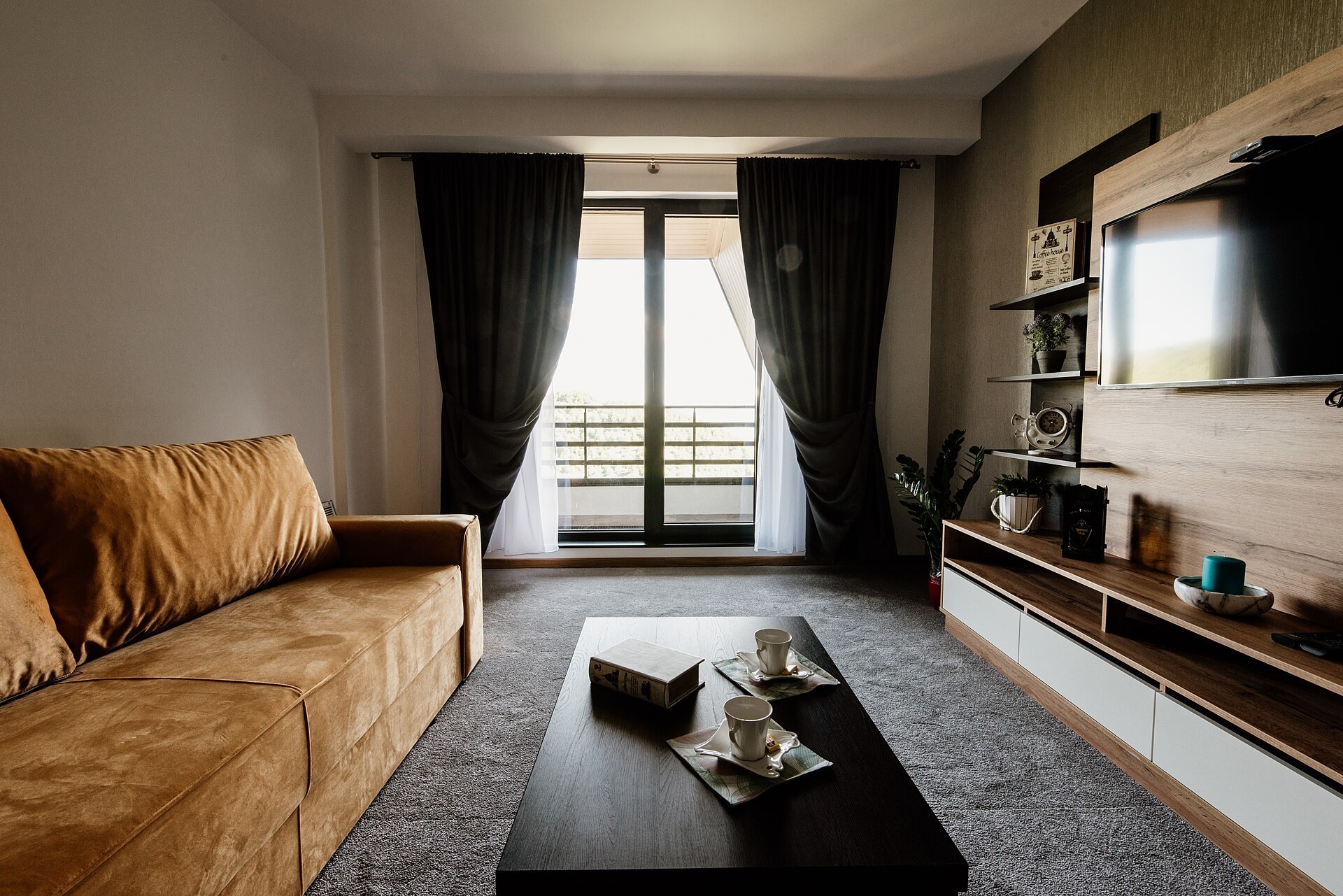 Contemporary living room with a tan sofa and timber media unit