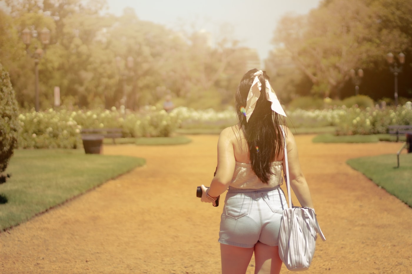 A British listener walking through a park with headphones, the kind of mid-morning best british wellness podcasts 2026 moment that defines current UK audio habits