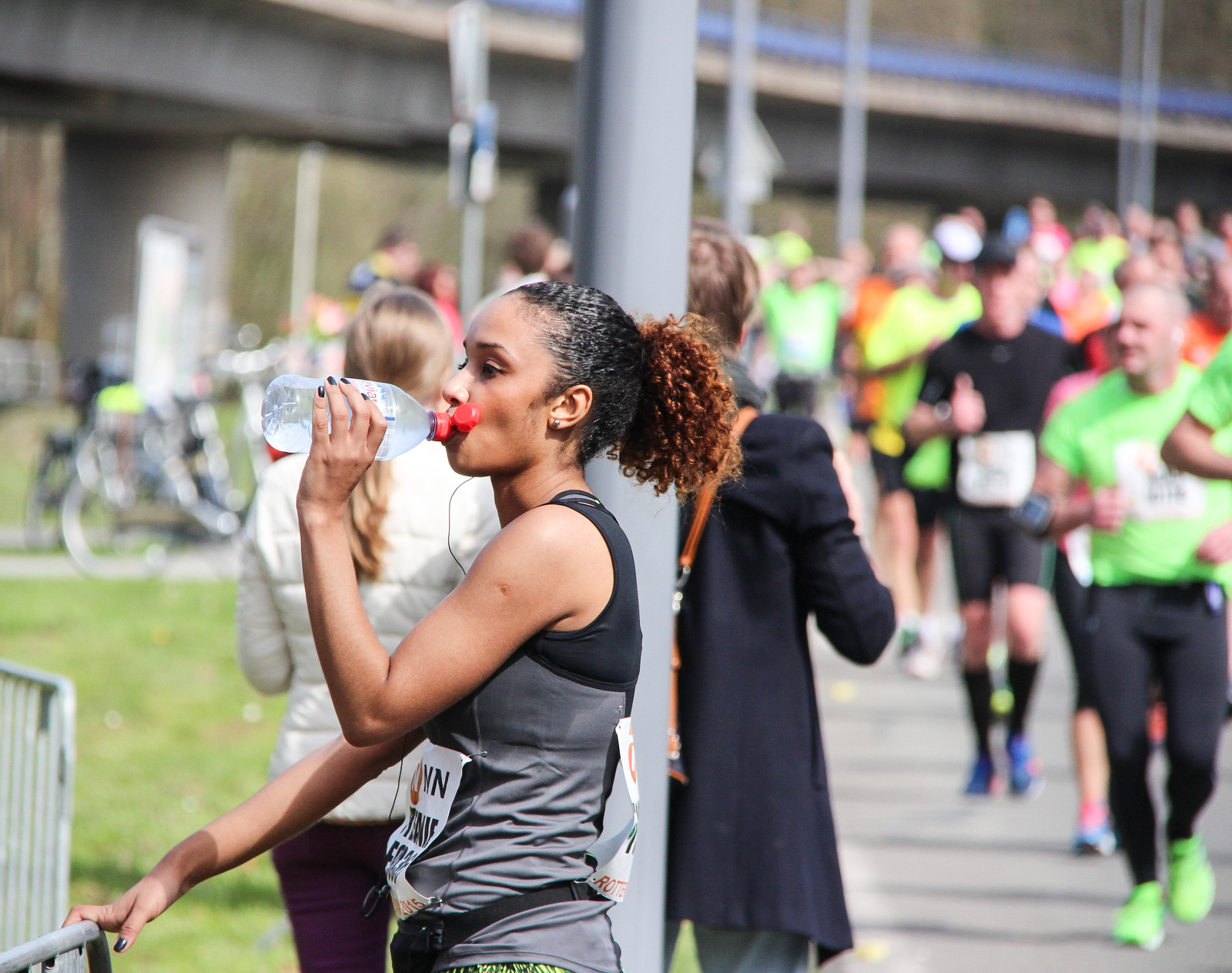 A runner pauses to drink during a marathon - sustained endurance efforts are where electrolyte replacement earns its keep