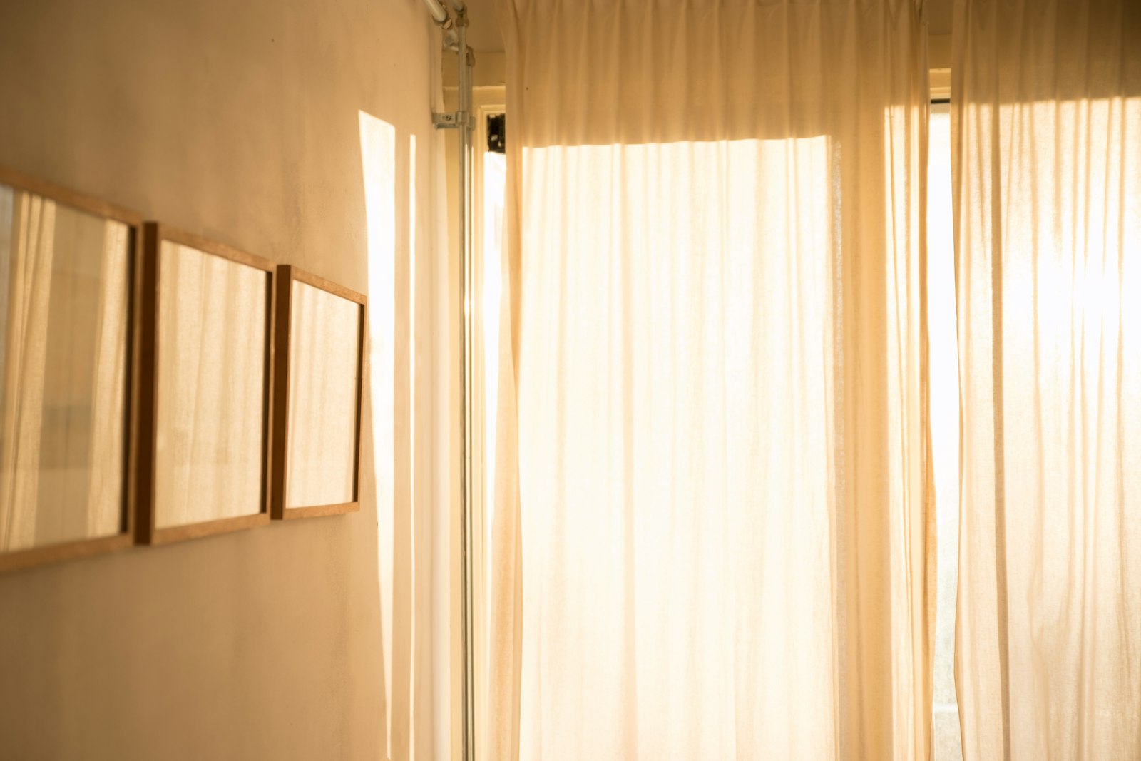 White curtains filtering strong summer sunlight in a living room