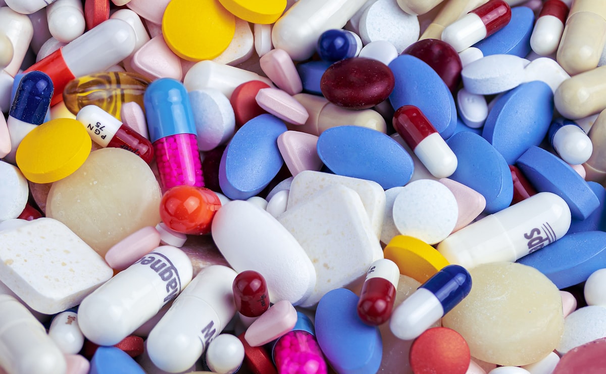 Supplement capsules and prescription tablets representing PCOS treatment options