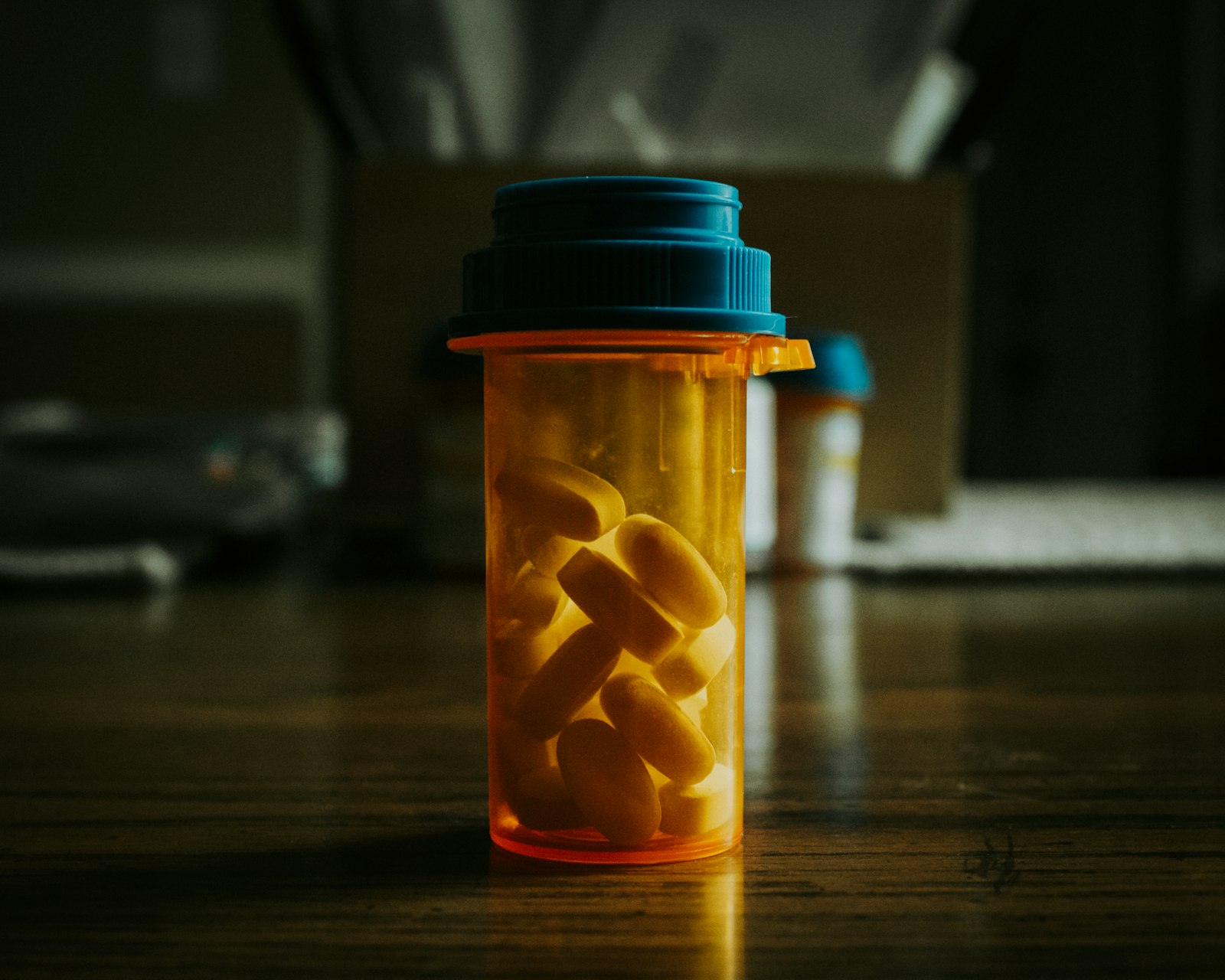 Supplement capsules in an amber bottle on a wooden table, representing UK saffron mood capsules