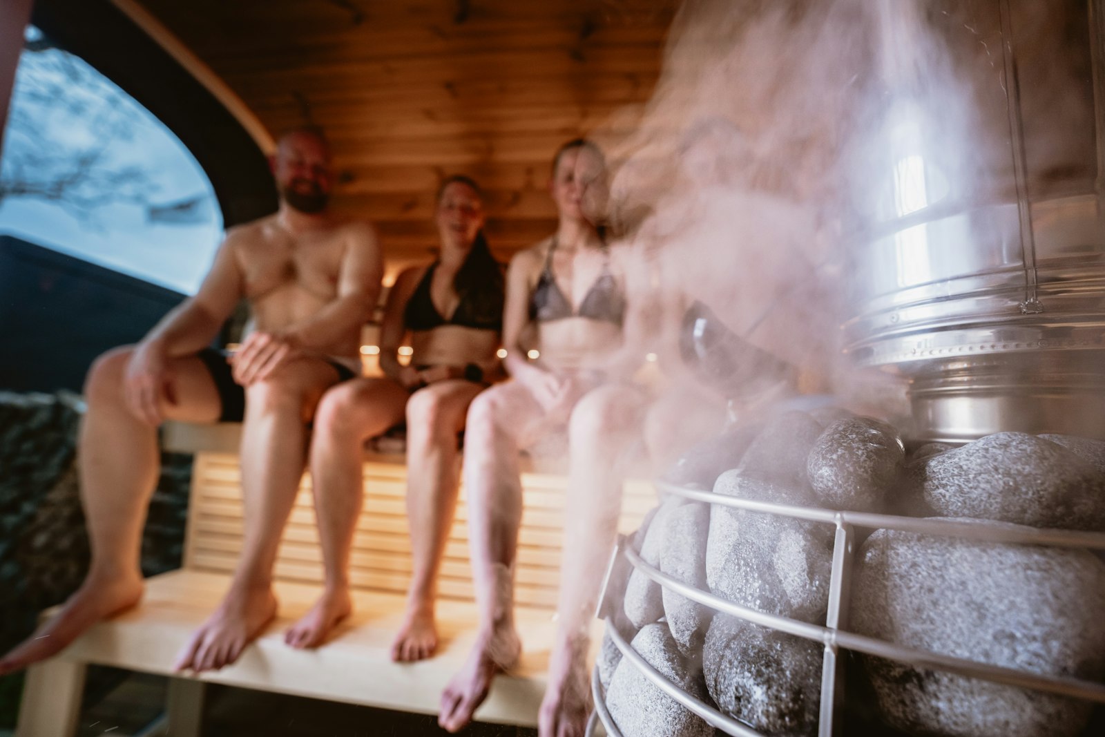 Bathers relaxing in a steamy communal sauna, the setting behind the sauna benefits UK researchers have documented