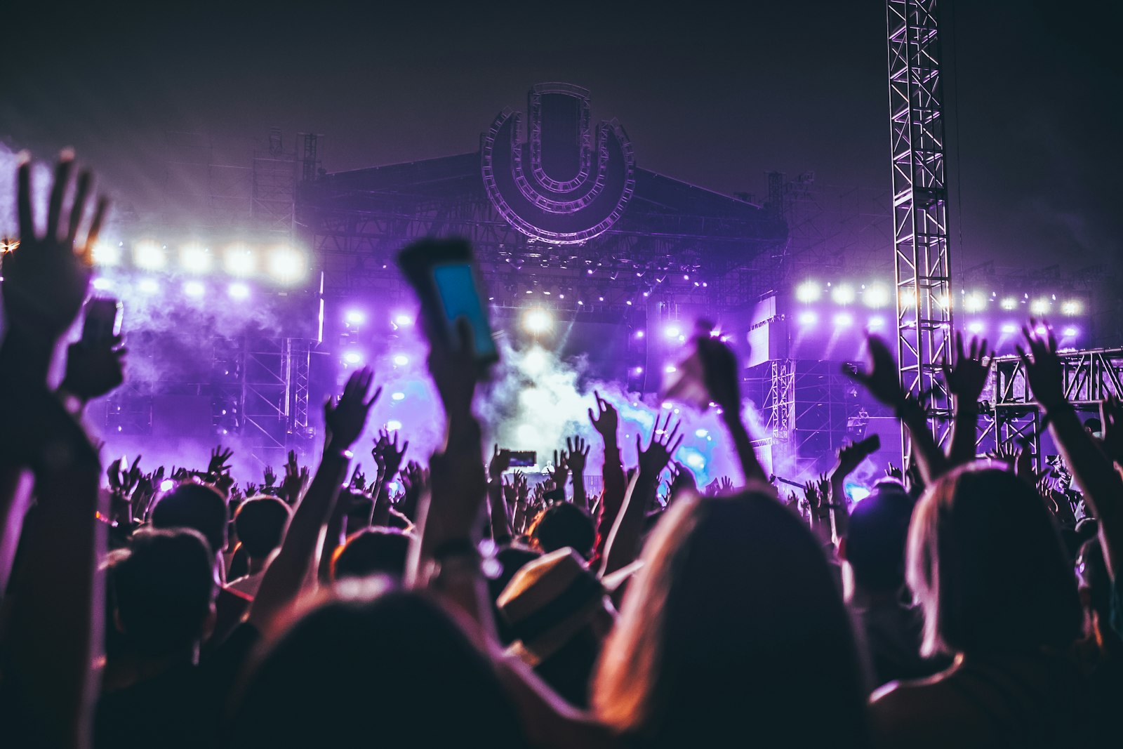 Arena crowd with hands raised at a major UK concert, the shows where the £1 ticket levy is collected