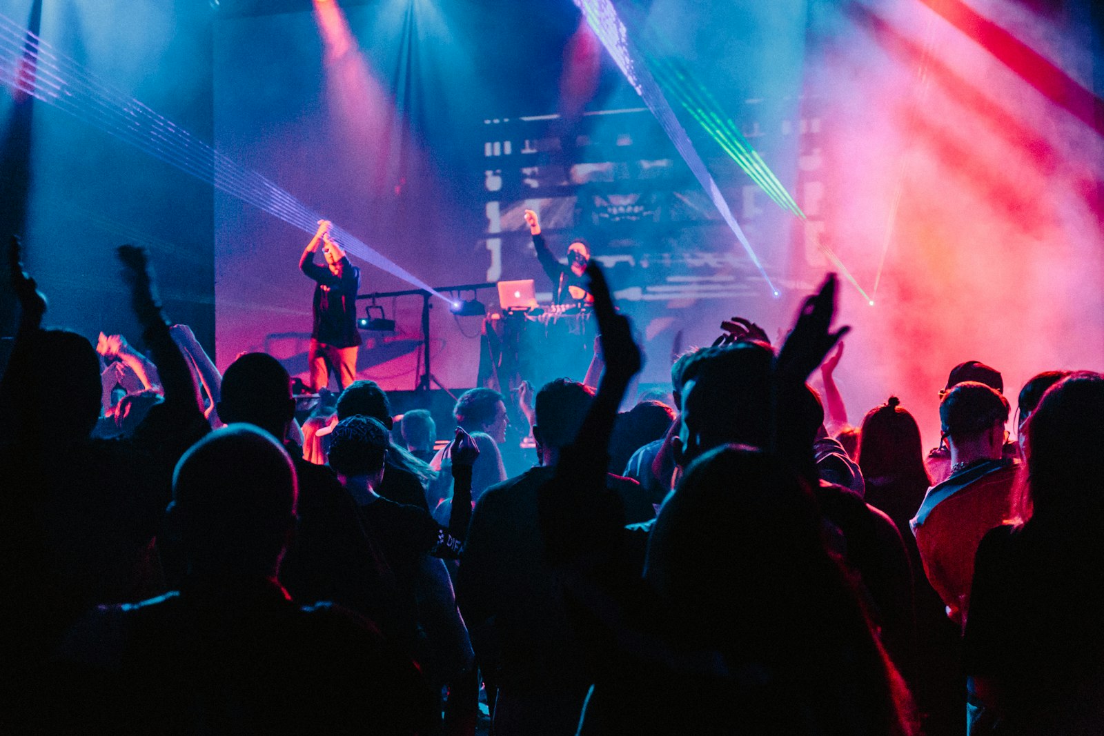 Singer performing under stage lights at an intimate venue