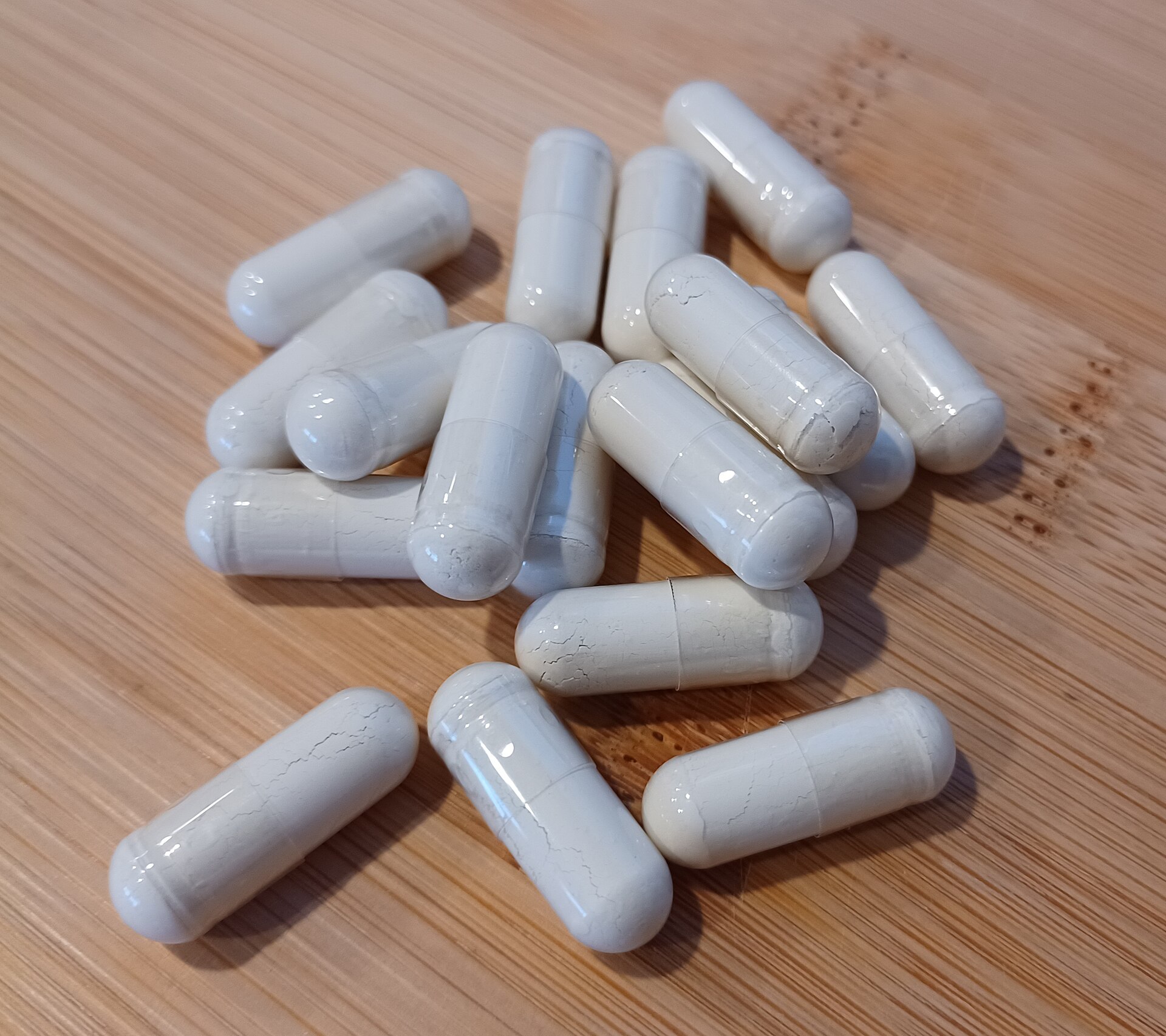 Tongkat ali supplement capsules tipped from a bottle, the format most of it is sold in across the UK