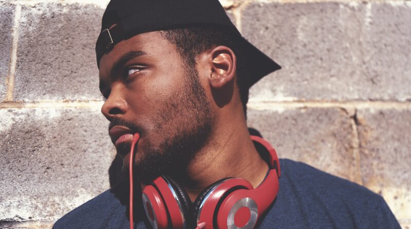 Person wearing red headphones listening to an audiobook - UK audiobooks 2026