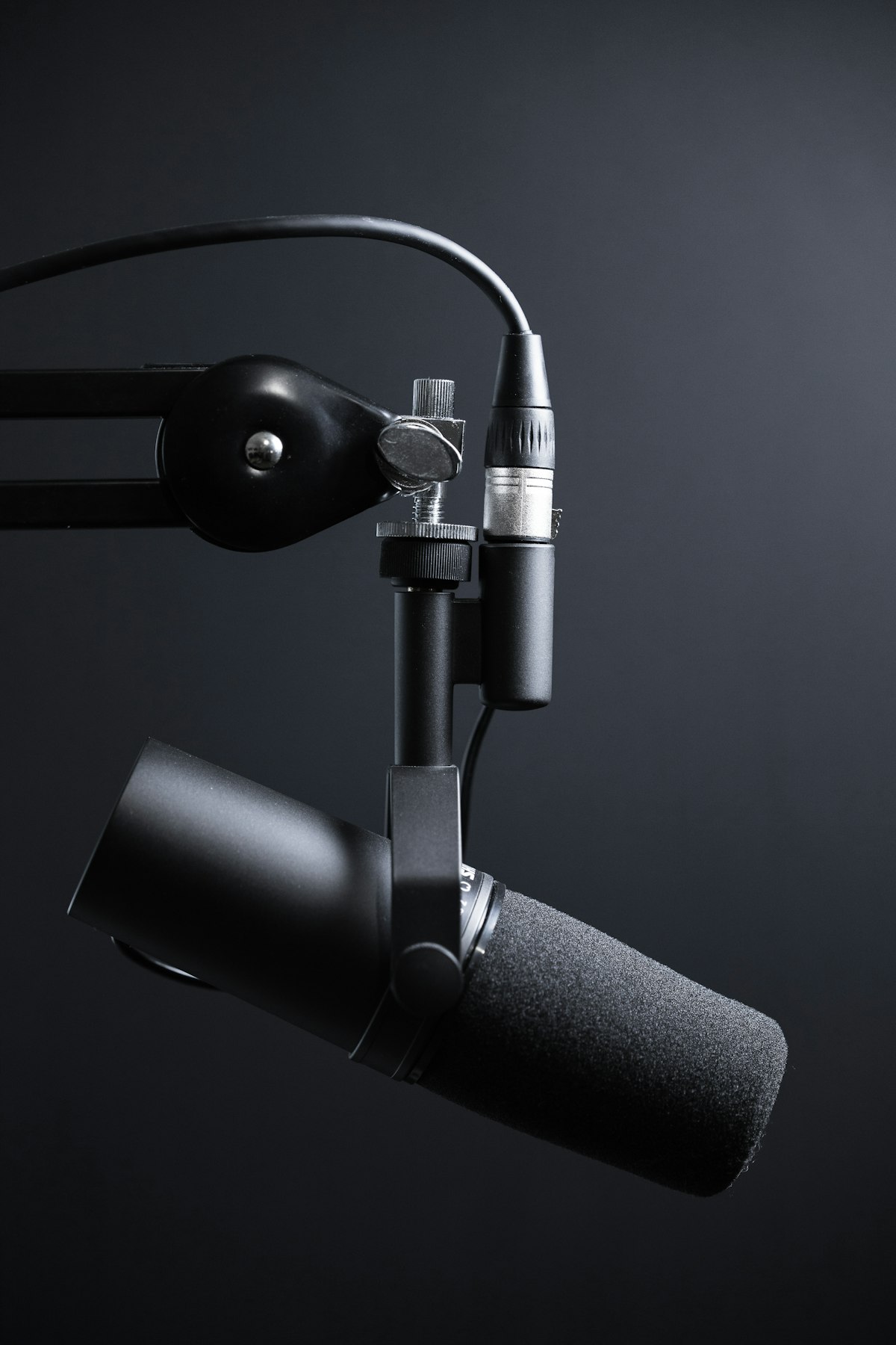 USB broadcast microphone mounted on a boom arm for home office video calls