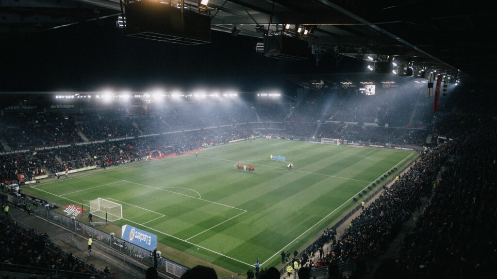 Floodlit football stadium full of fans at night - watch the World Cup 2026 in the UK free on BBC and ITV