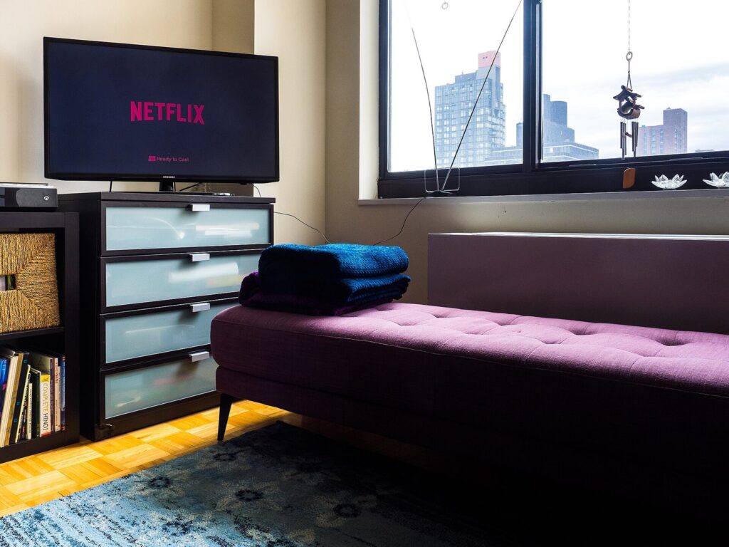 Netflix on a smart TV - a viewer settling in to watch a series at home