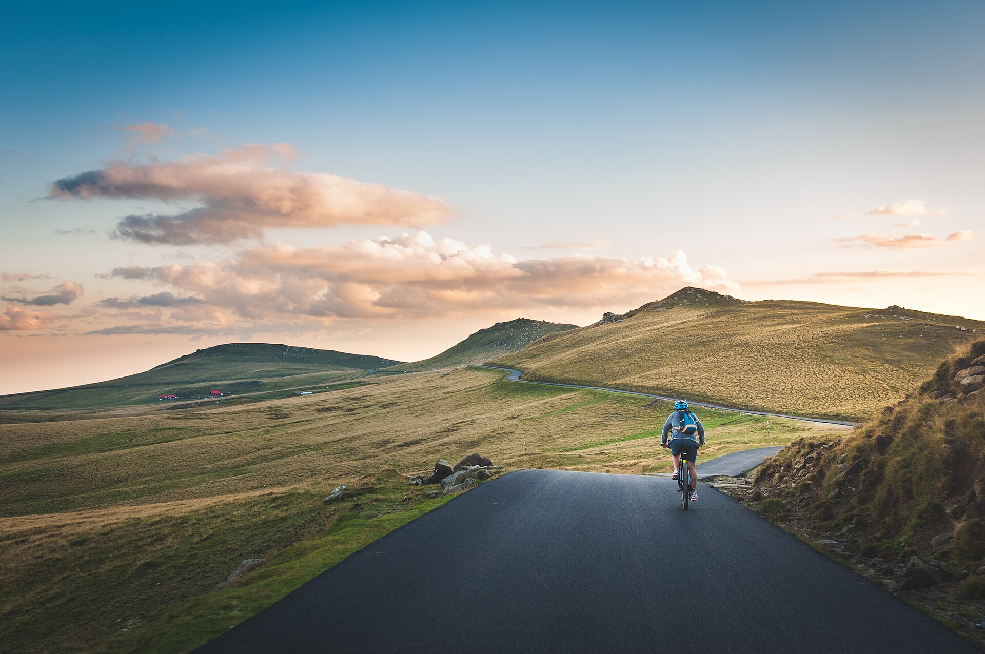 A cyclist on a quiet countryside road, one of the easiest ways to hold a zone 2 effort