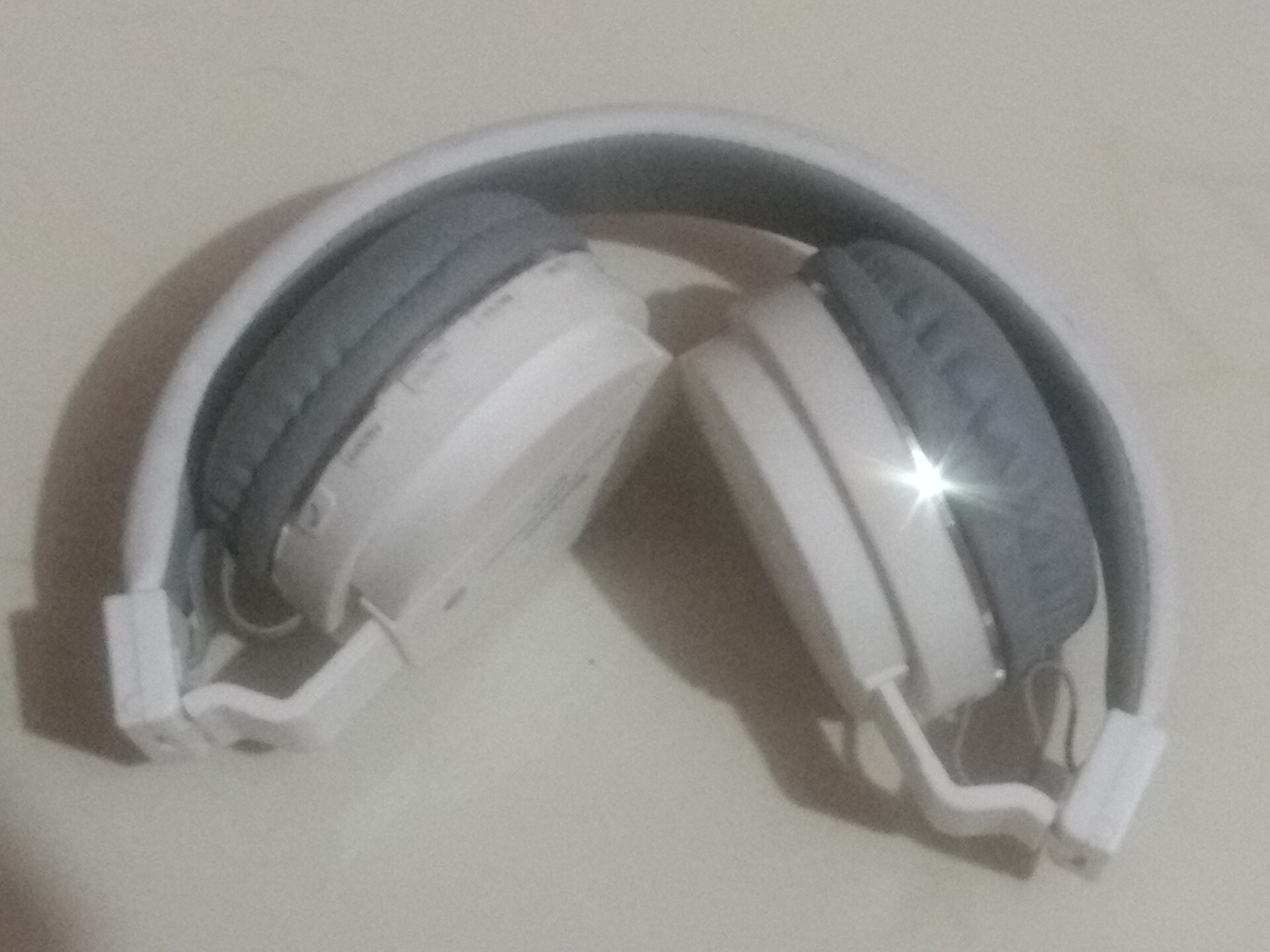 A pair of over-ear headphones resting on a table