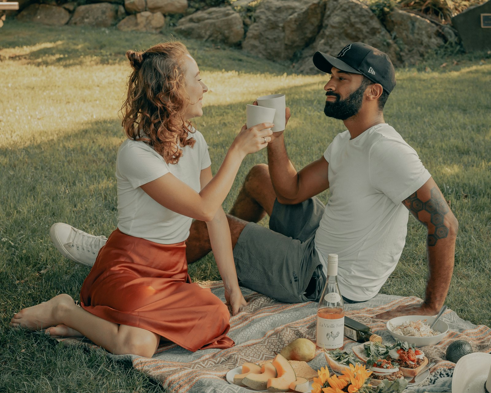 Couple eating picnic food kept cold outdoors on a summer day