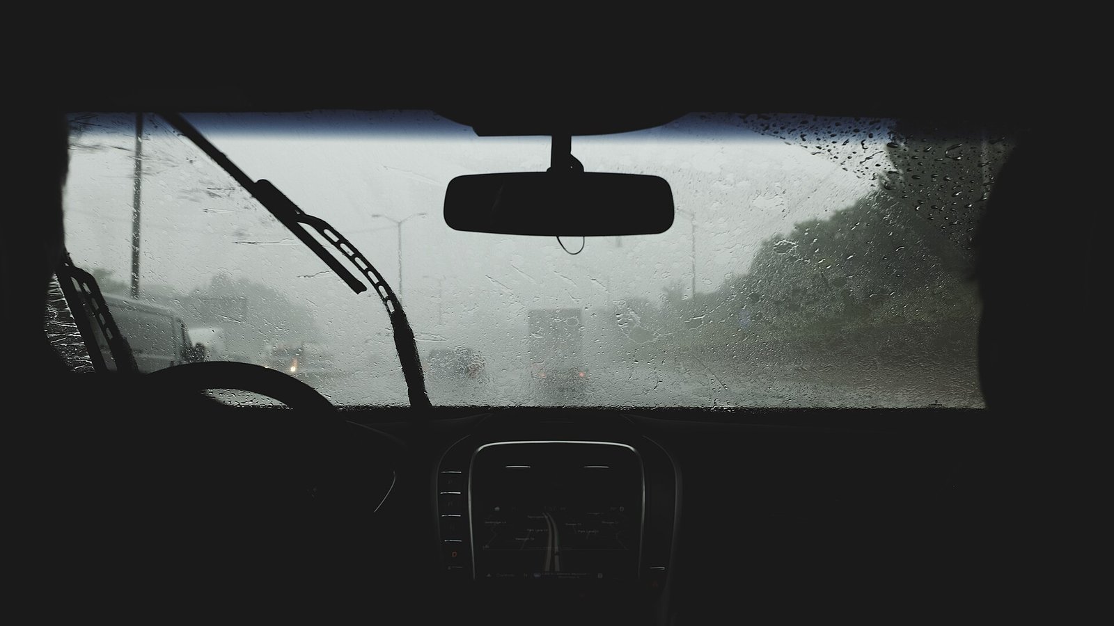 Heavy rain seen through a car windscreen, the low-light conditions that separate budget dash cams