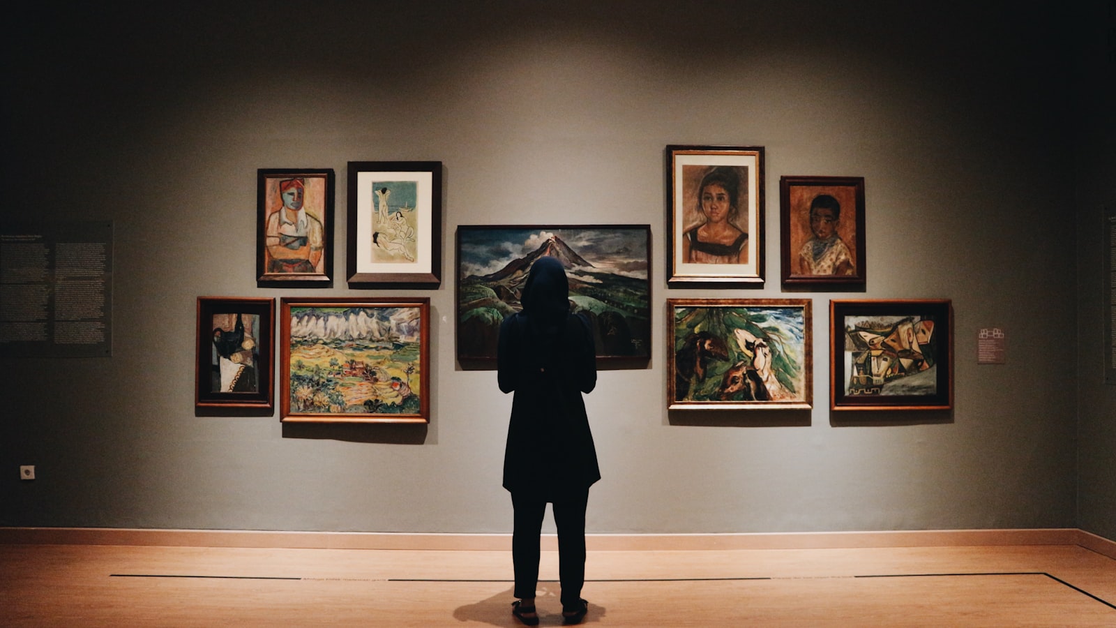 Visitor standing in front of paintings at one of the best London exhibitions summer 2026 has to offer