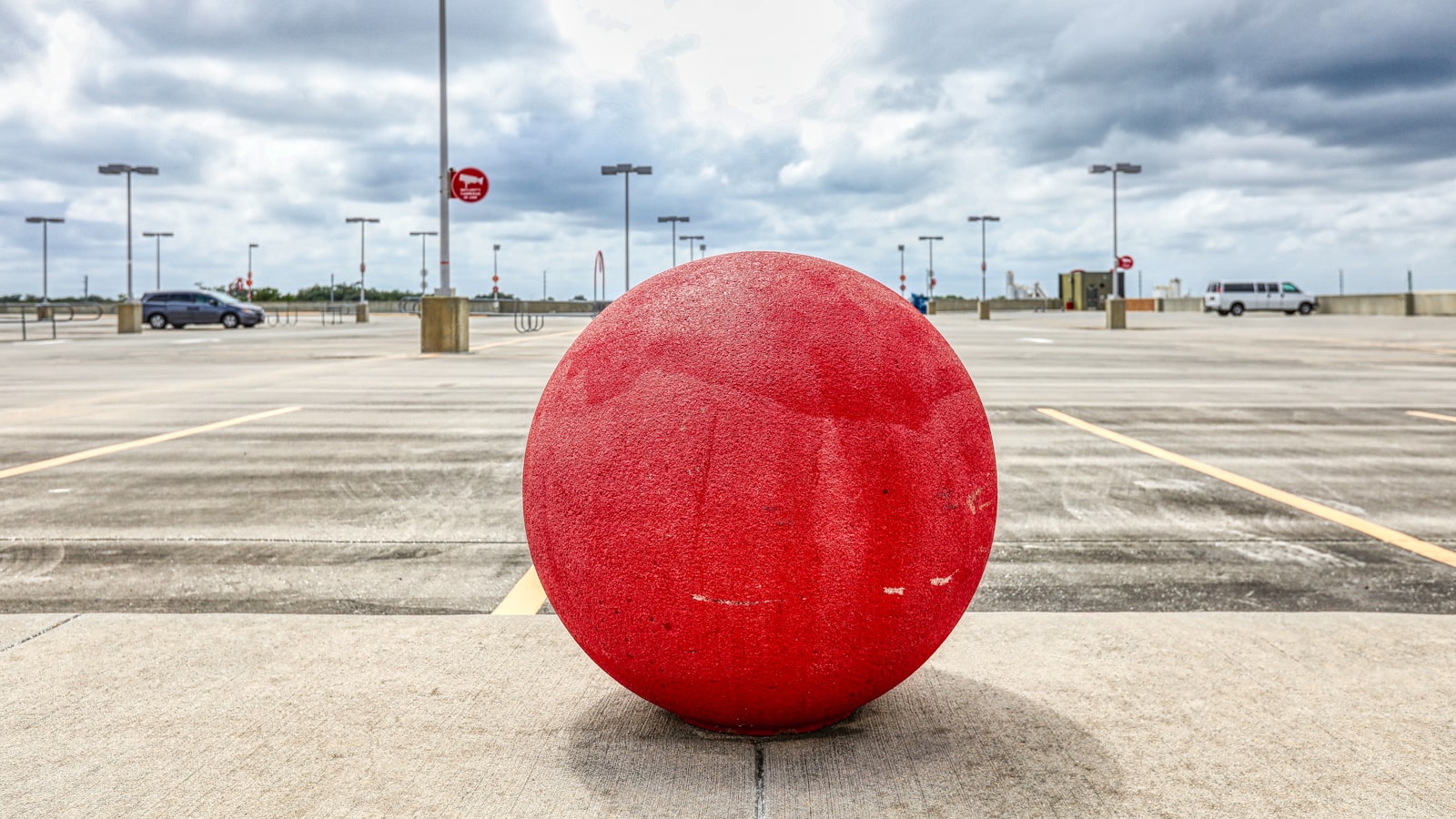 Giant red spherical sculpture of the kind Anish Kapoor has made his signature