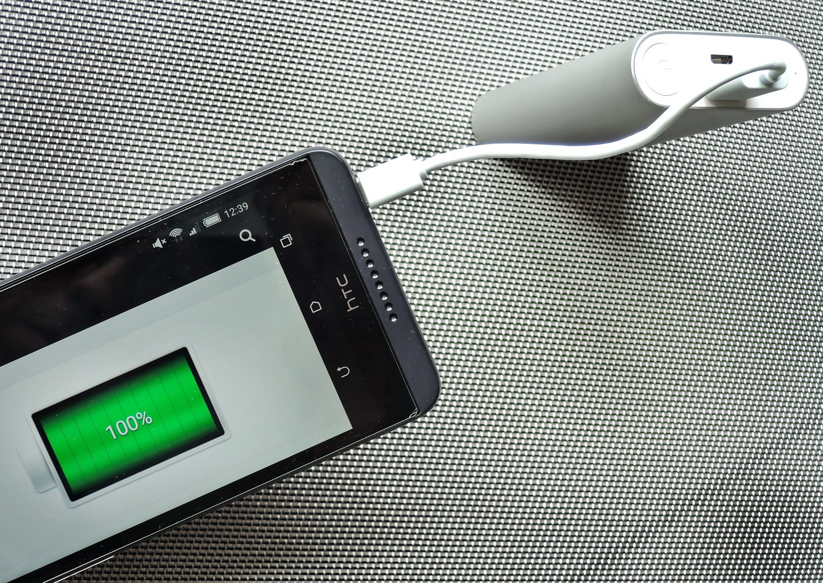 Smartphone being charged from a small USB power bank
