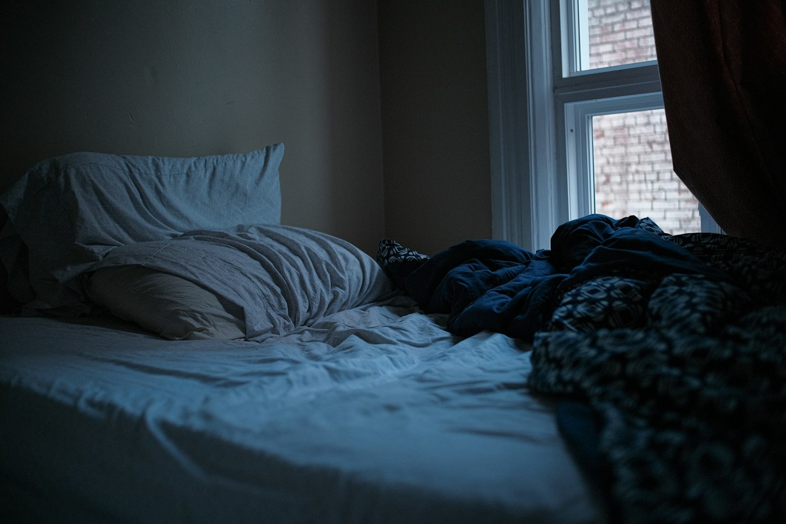 A dark, quiet bedroom on a summer night