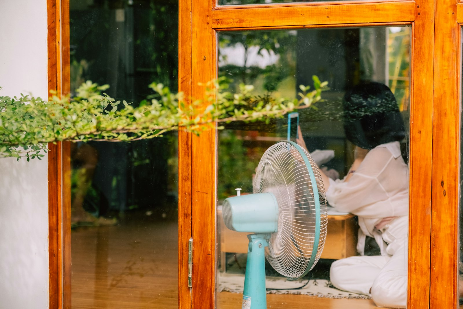 Fan positioned by a window to pull cooler evening air into the room