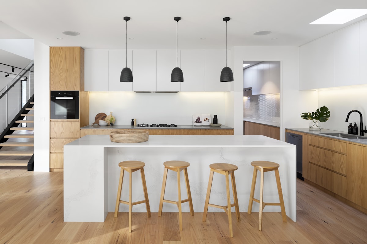 Open-plan kitchen with large island and doorway through to a separate back kitchen
