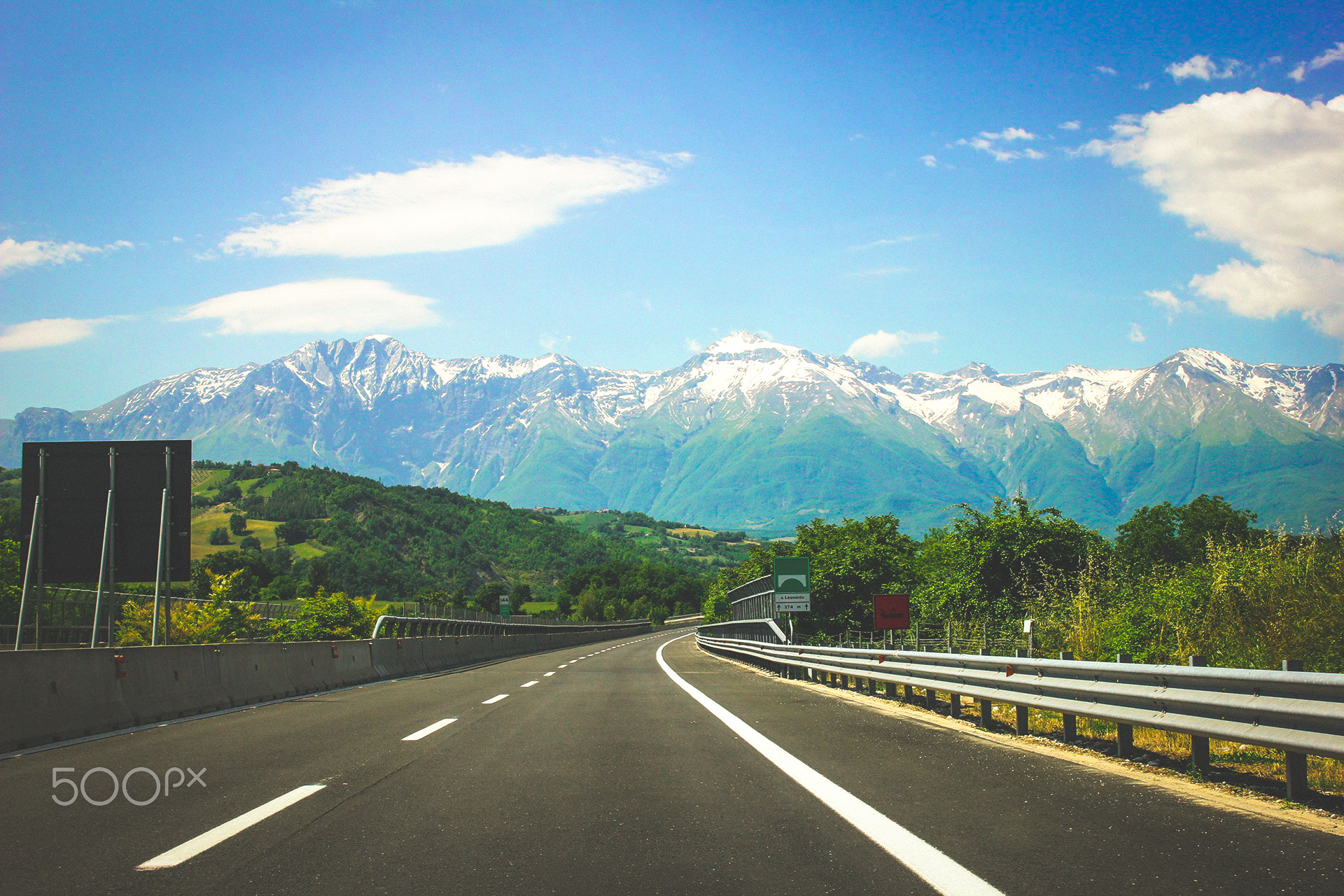 Hire car on a European road in summer - car hire excess insurance covers the risk for a few pounds a day