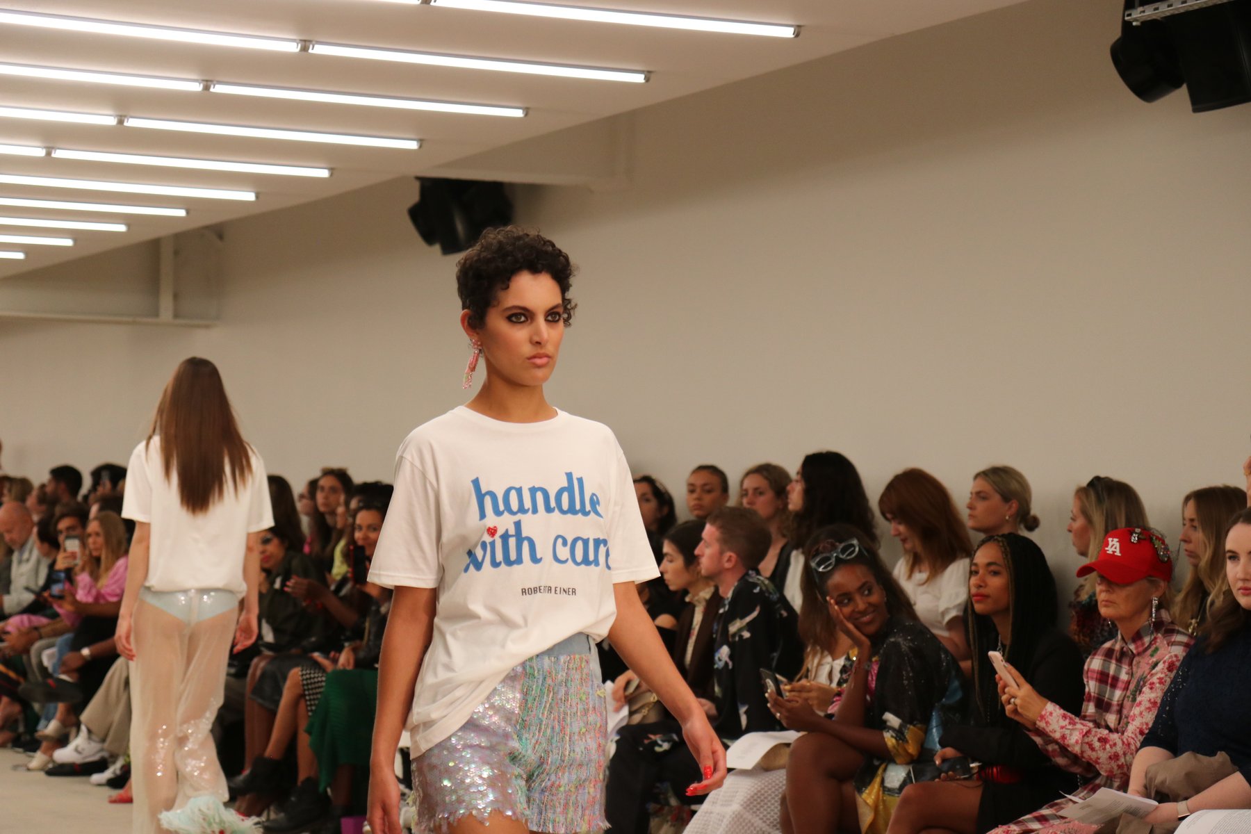 Models walking a London Fashion Week catwalk, the world that SS26 takes apart