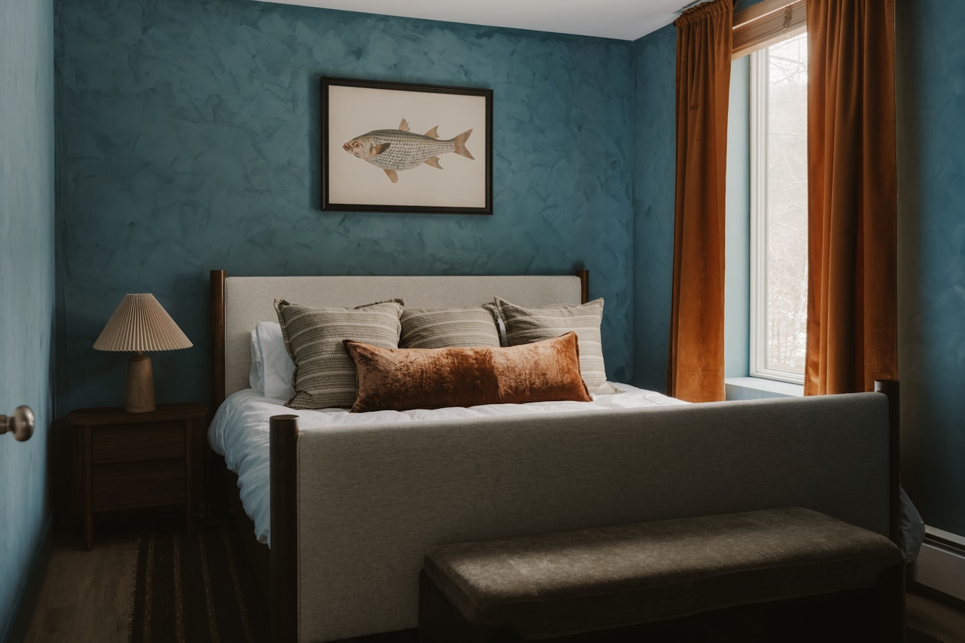 Colour drenching in a bedroom with deep blue walls carried across every surface