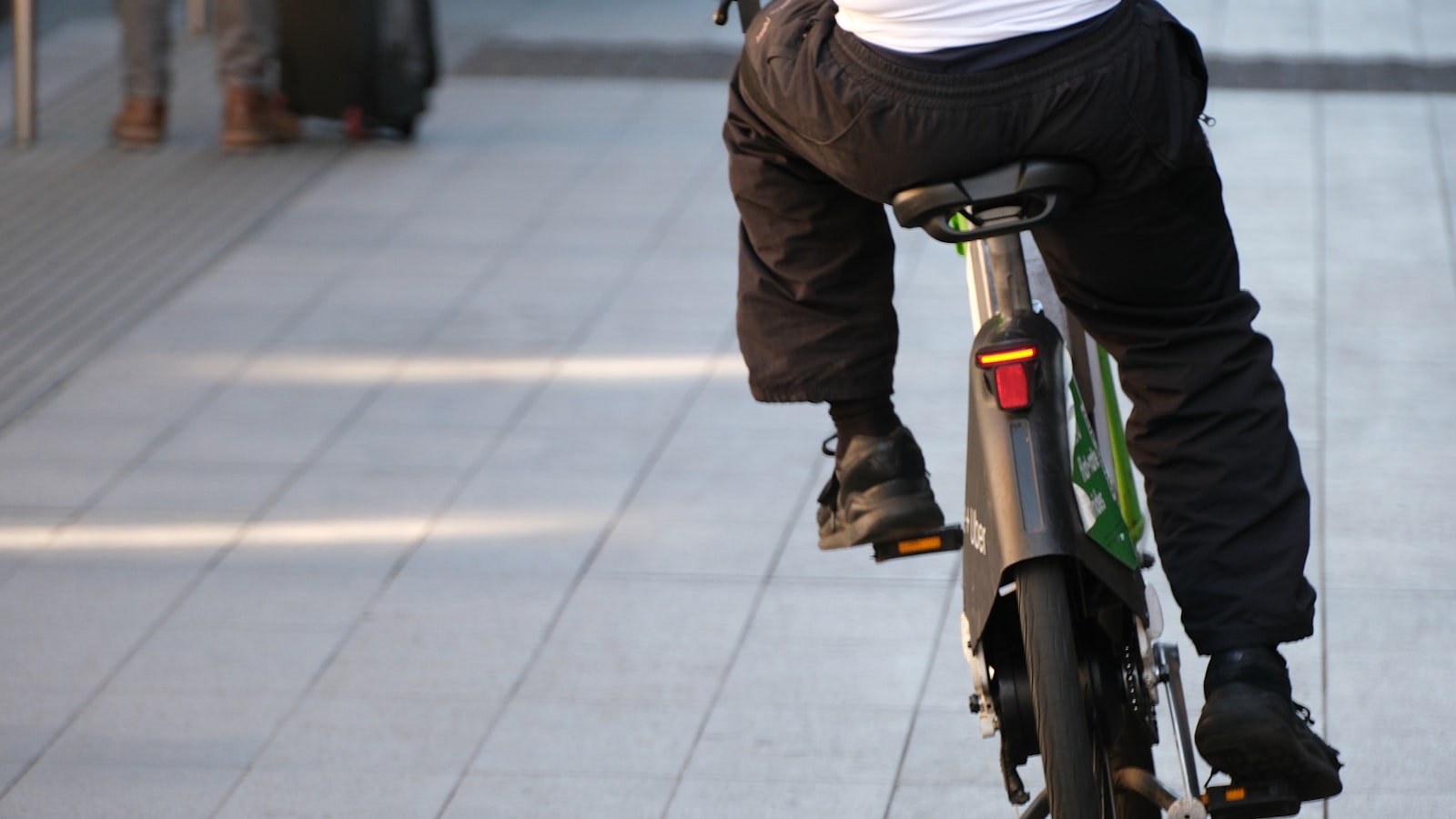 A commuter e-bike under £1,500 ridden along a city pavement
