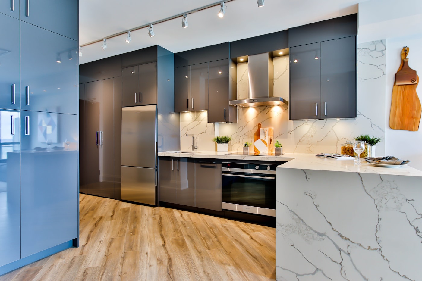 Compact modern kitchen using full-height wall units for storage