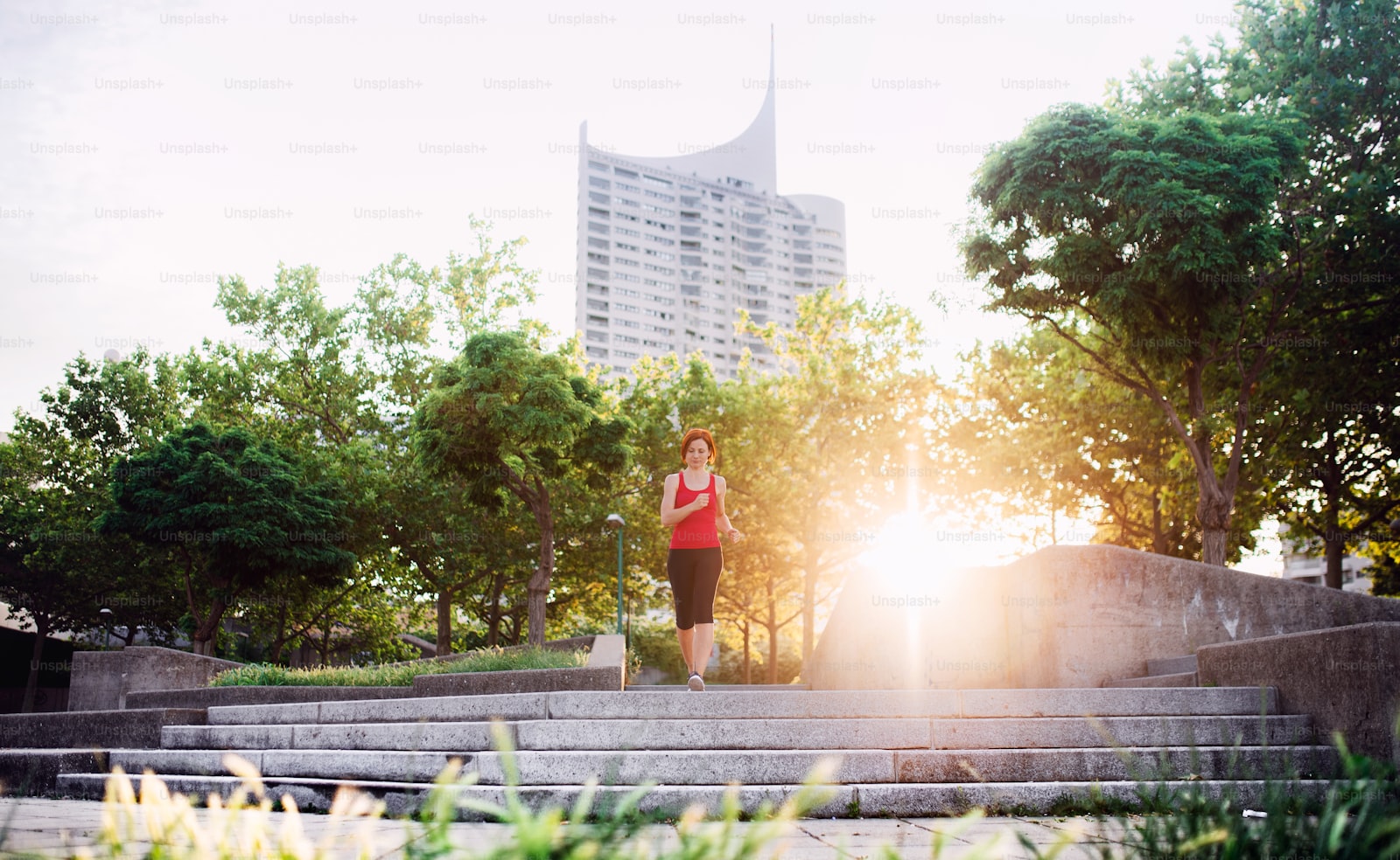 A woman running outdoors at sunrise, one of the few things that genuinely helps a cortisol detox