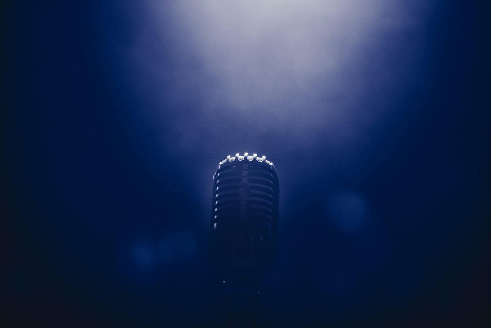 Stage microphone under low light at a comedy show