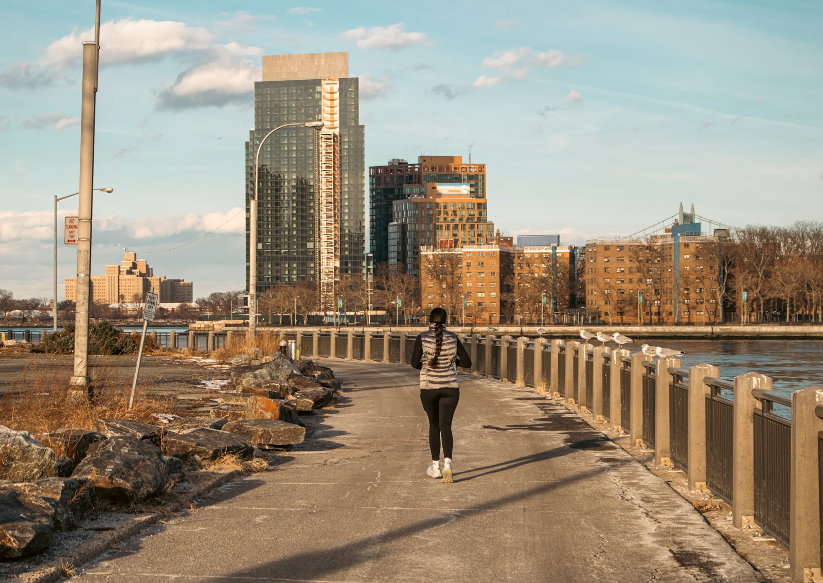 A runner exercising in a heatwave on a city path early in the morning
