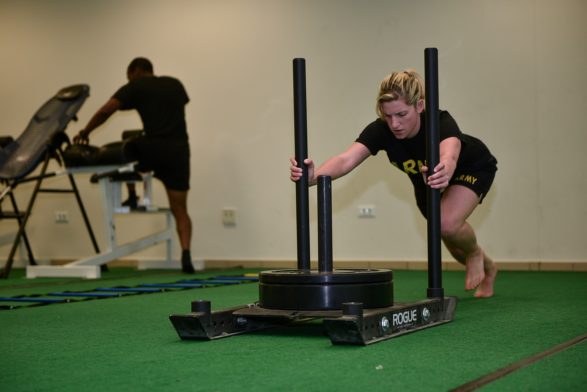 Athlete driving a weighted sled, the station that anchors most hyrox training plans