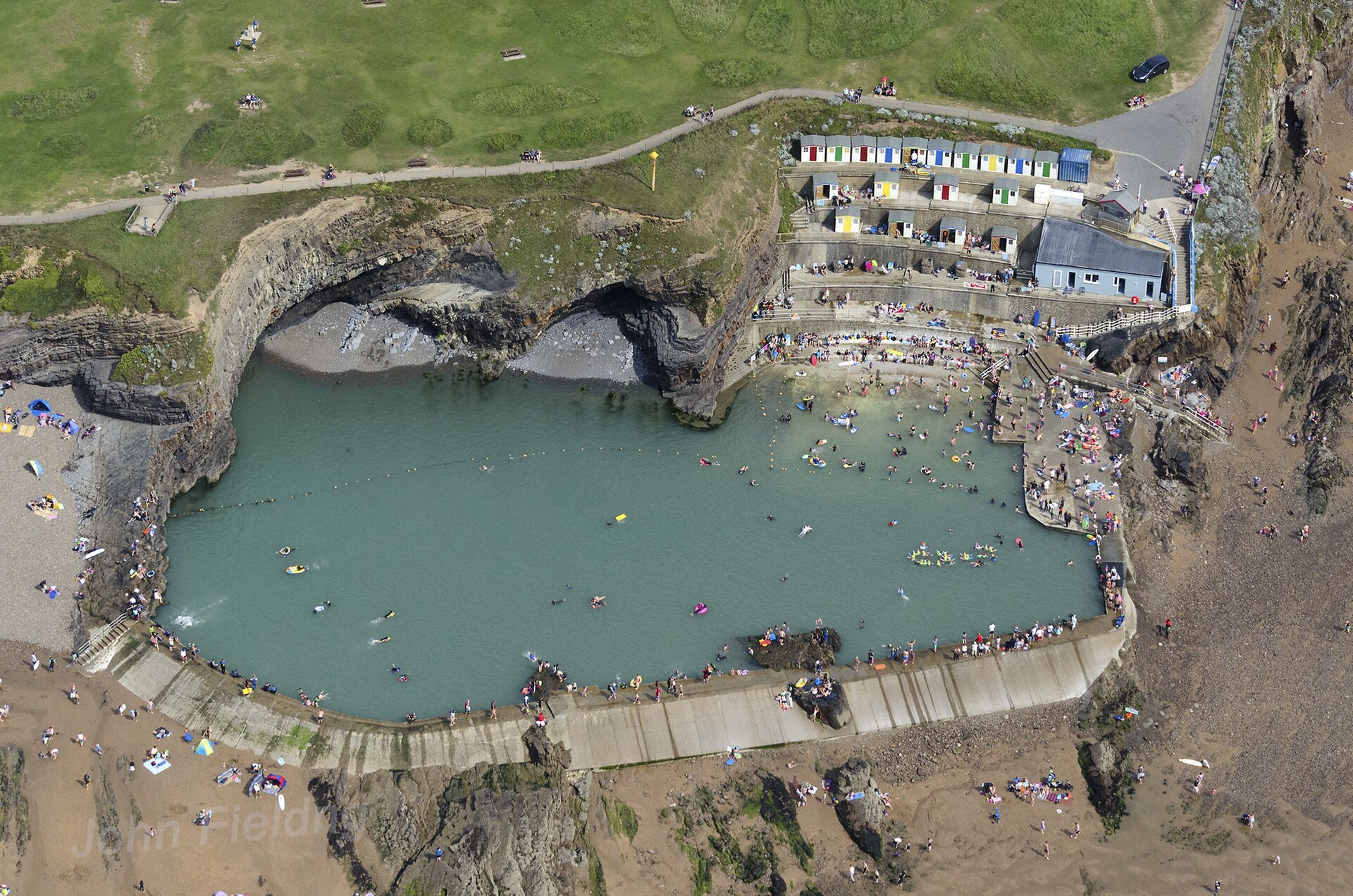 Swimmers in the tidal sea pool at Bude, Cornwall - open-air cold water swimming has gone mainstream in Britain
