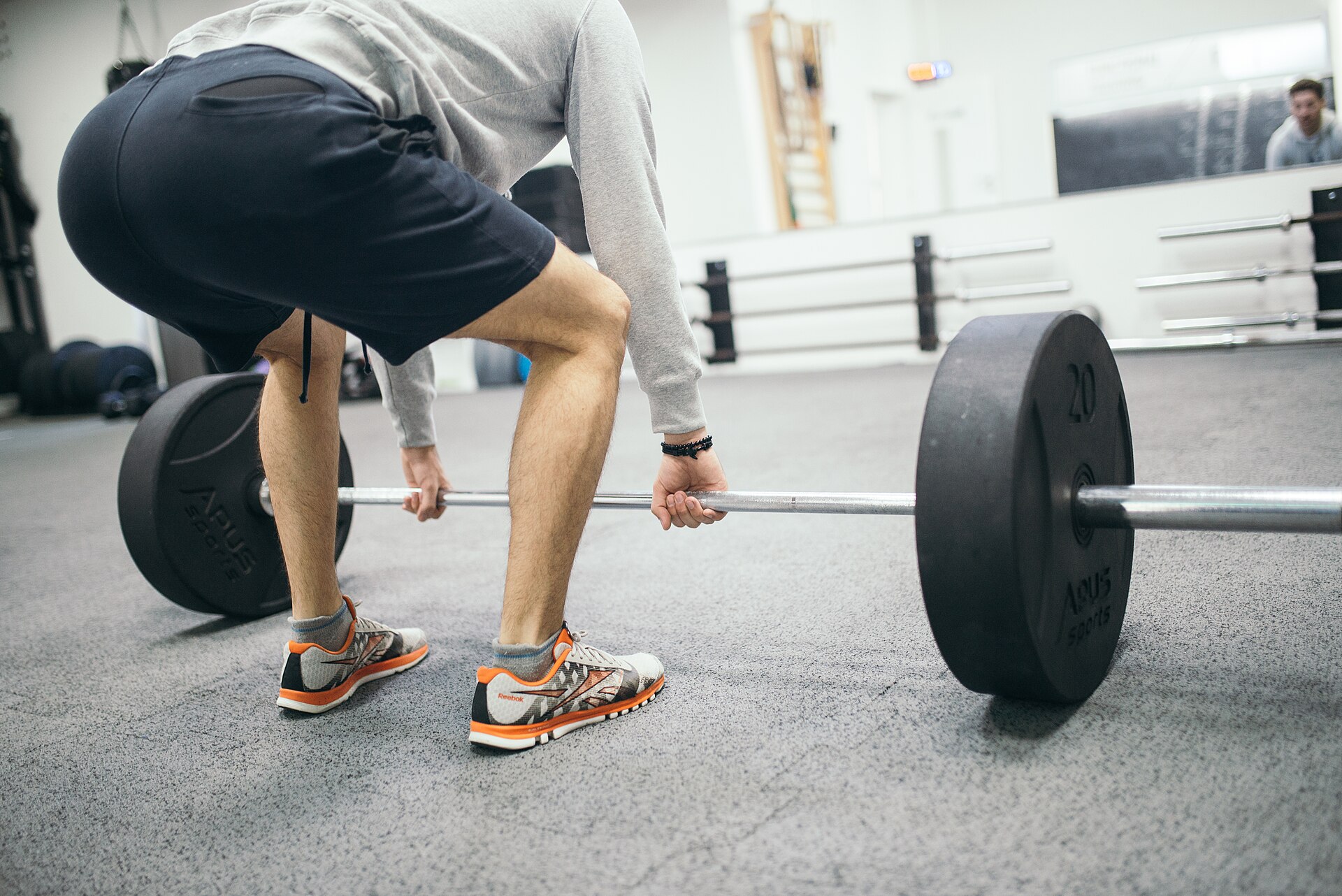 A lifter setting up a deadlift in a gym - plunging straight after training can blunt strength and muscle gains