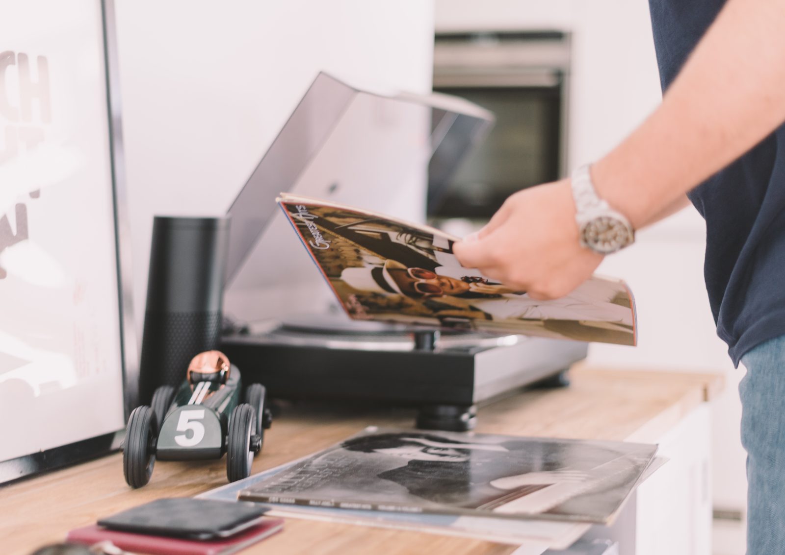 A man studying the sleeve of a vinyl record before putting it on