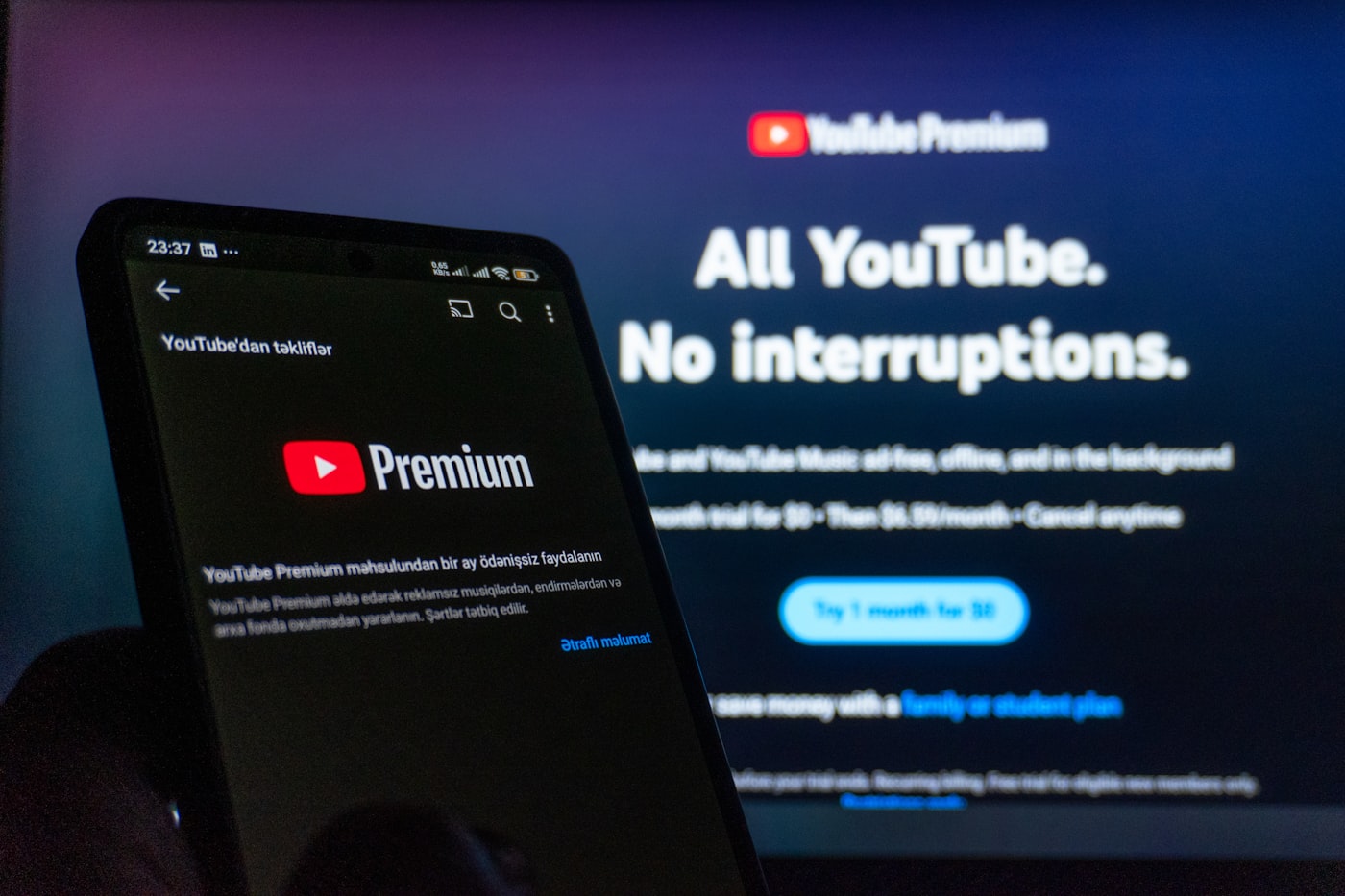 YouTube open on a smartphone in front of a television screen