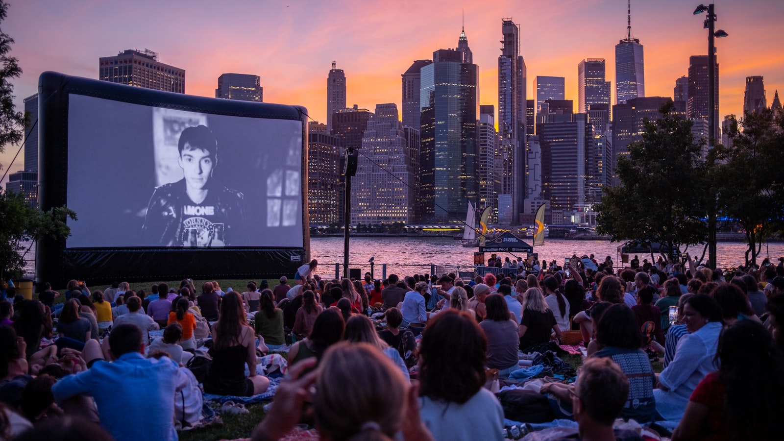 Outdoor cinema UK 2026: a crowd watching an open-air screen at dusk