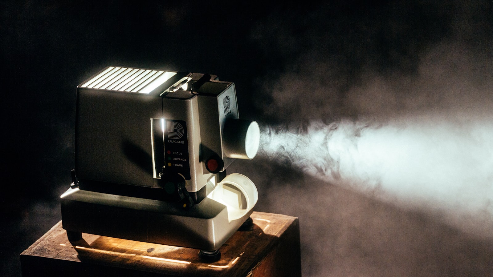 A film projector running as the light fades at an outdoor screening
