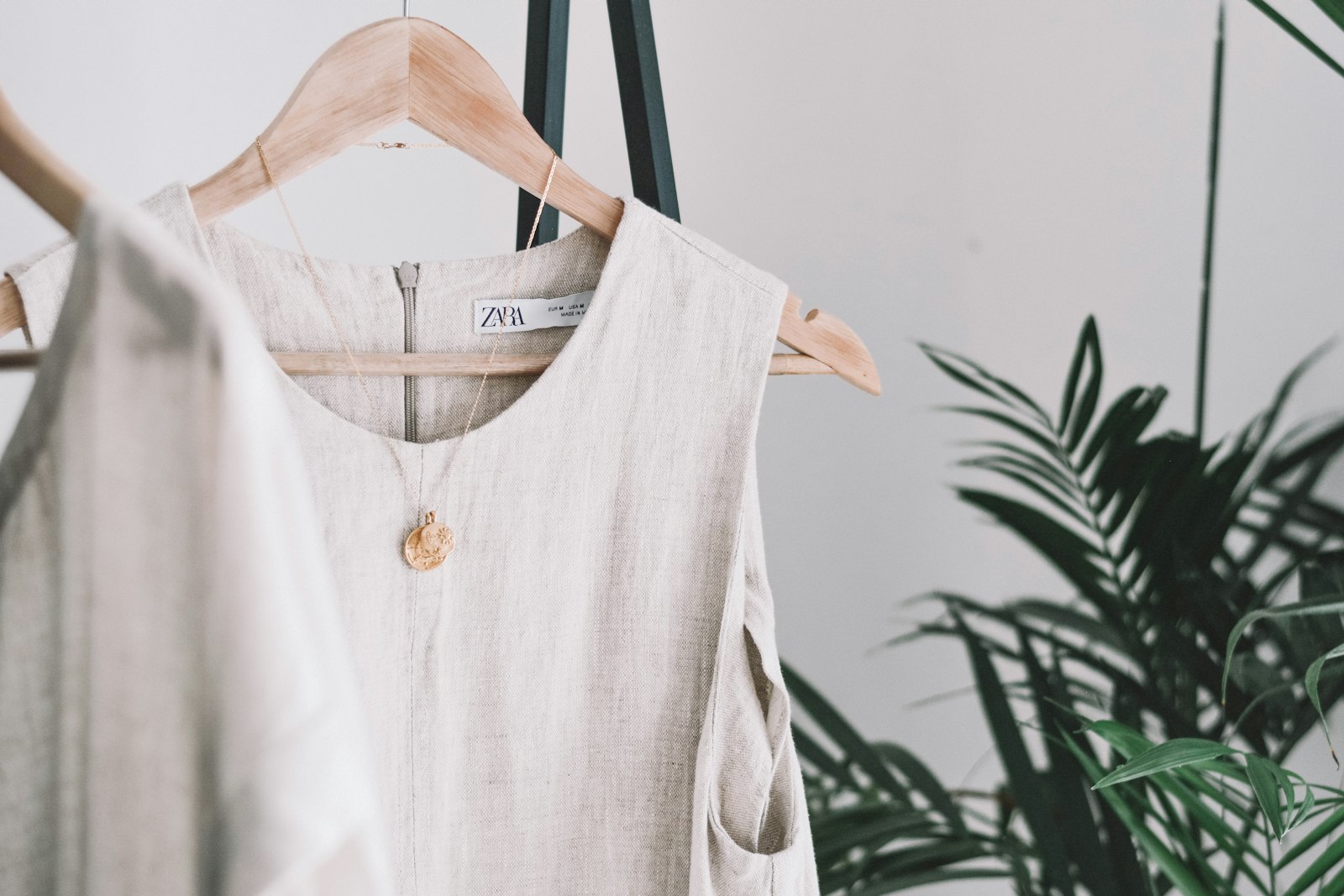 Loose beige linen clothing hanging up - breathable fabric that helps prevent prickly heat