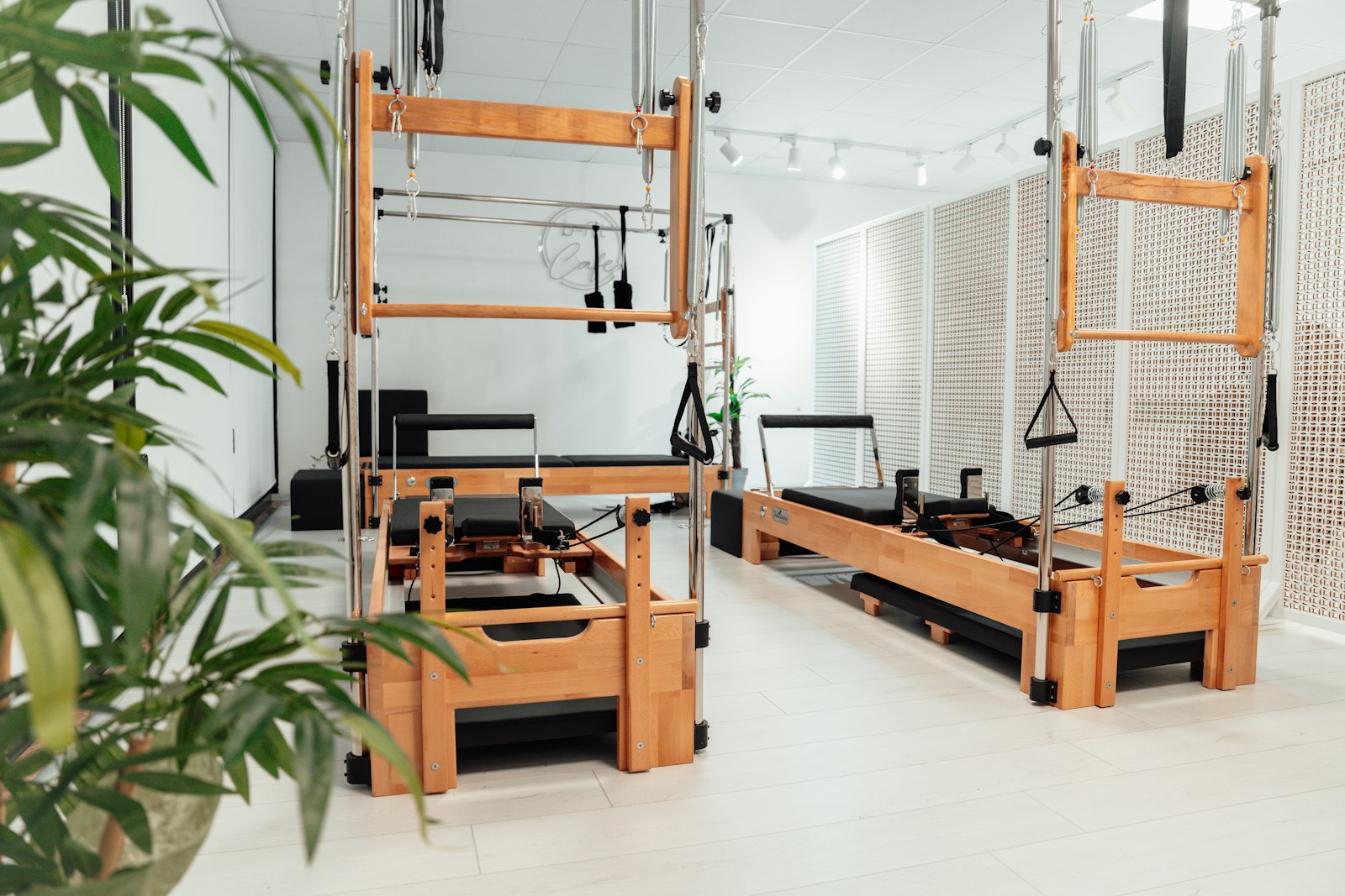 A reformer Pilates UK studio lined with machines between classes