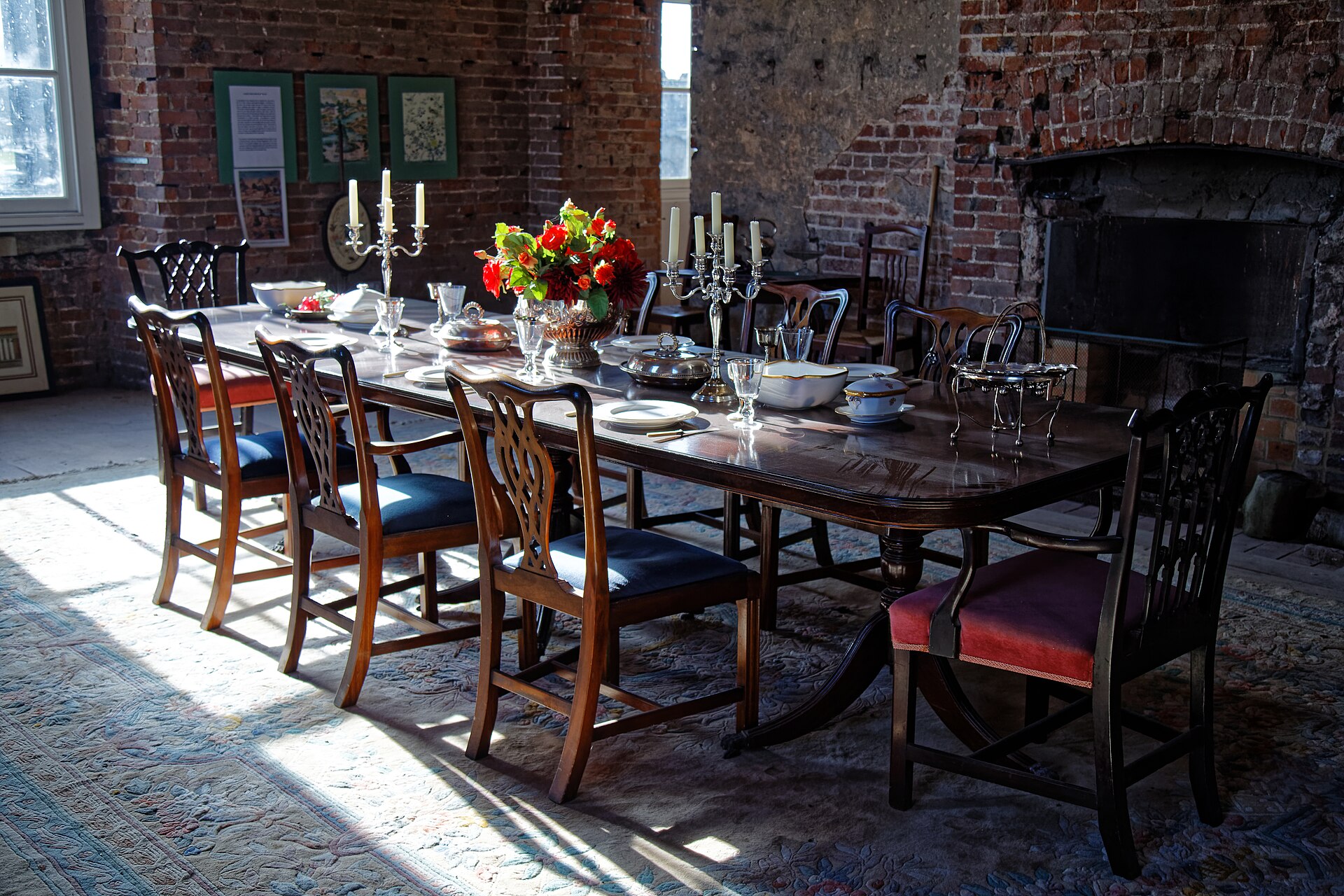 Candlelit table laid for dinner guests in a separate dining room