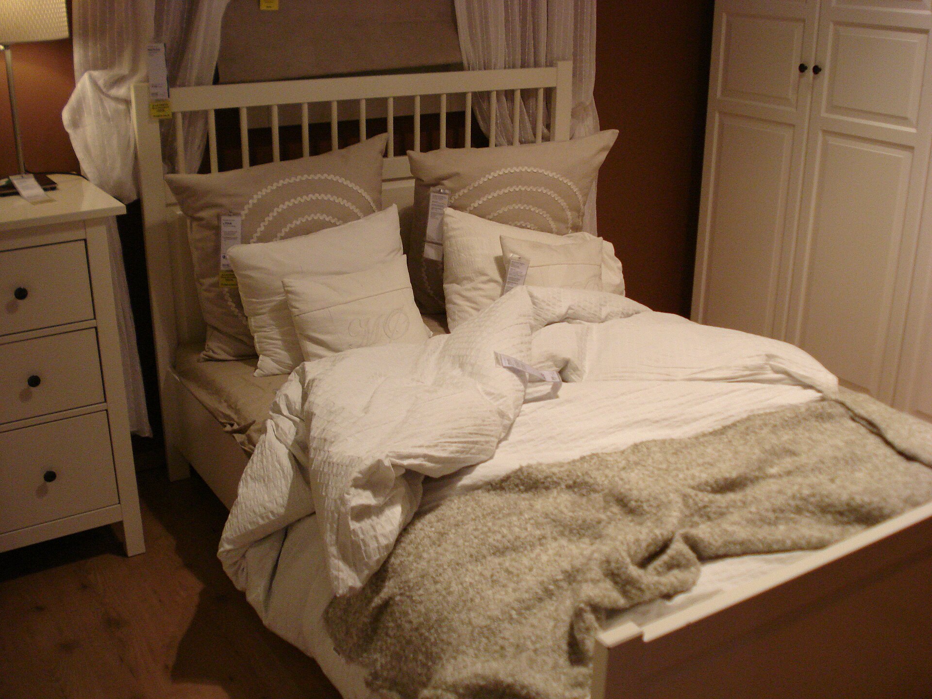 An unmade double bed in morning light - the lived-in second bedroom is the giveaway most couples stop hiding