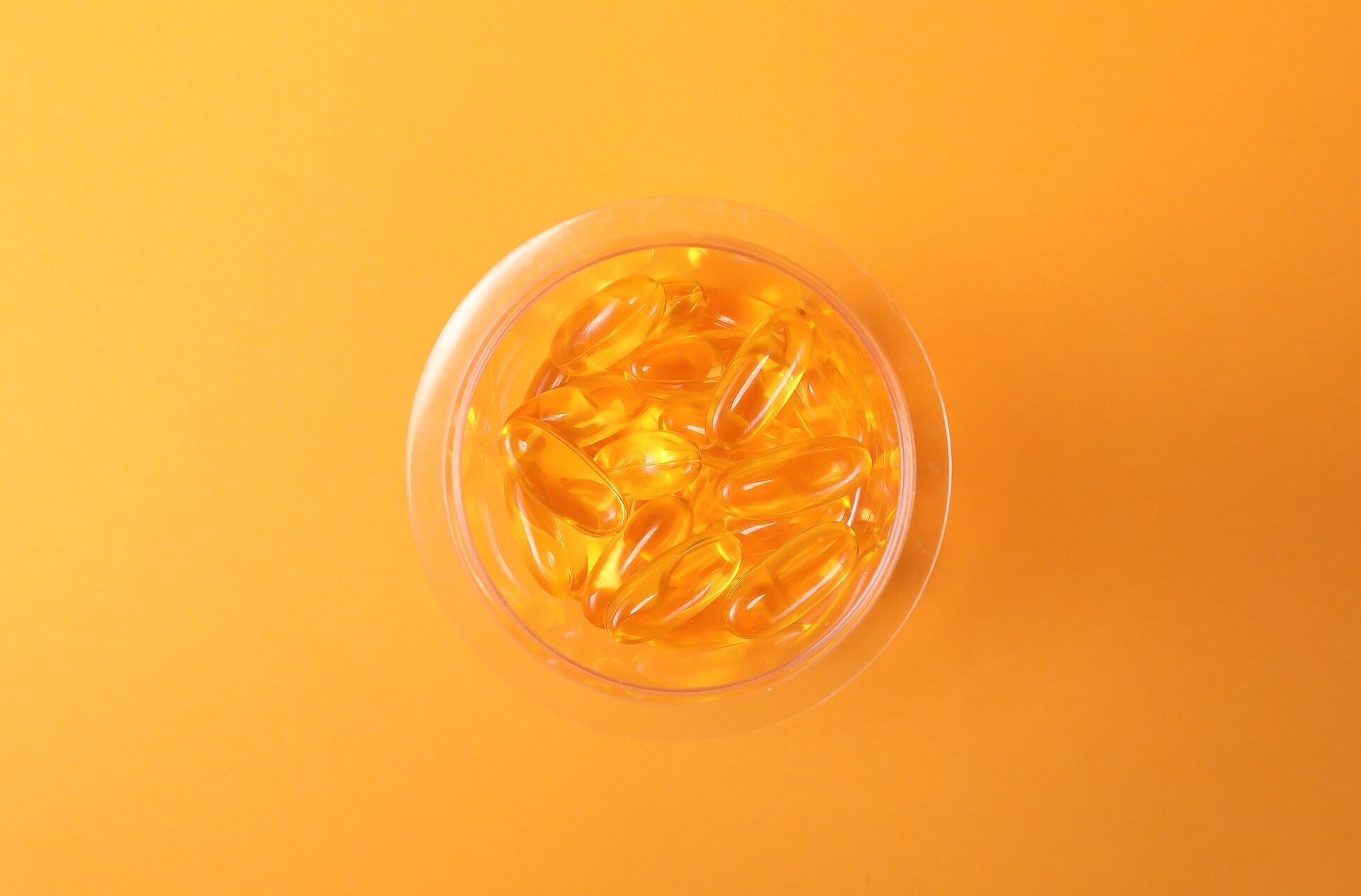 Supplement capsules spilling from a white bottle, the format most ashwagandha is sold in