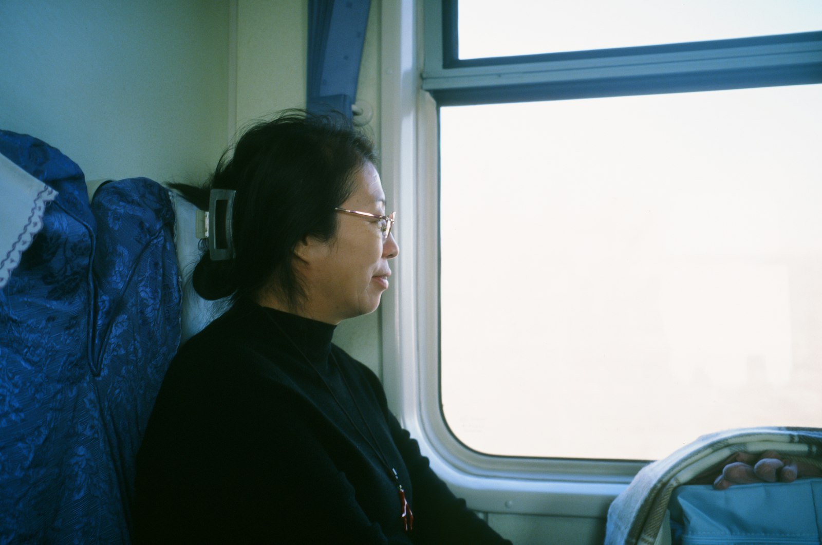 Woman looking out of a train window mid-journey