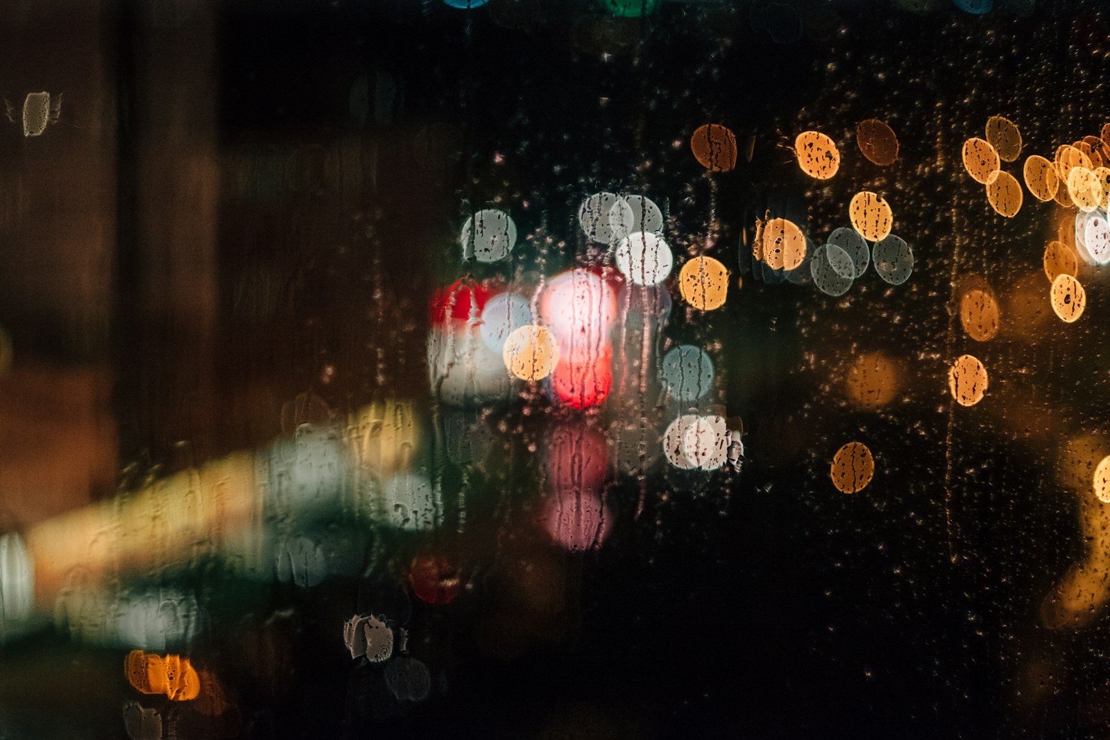 Rain-streaked window with blurred lights, classic British bank holiday weather