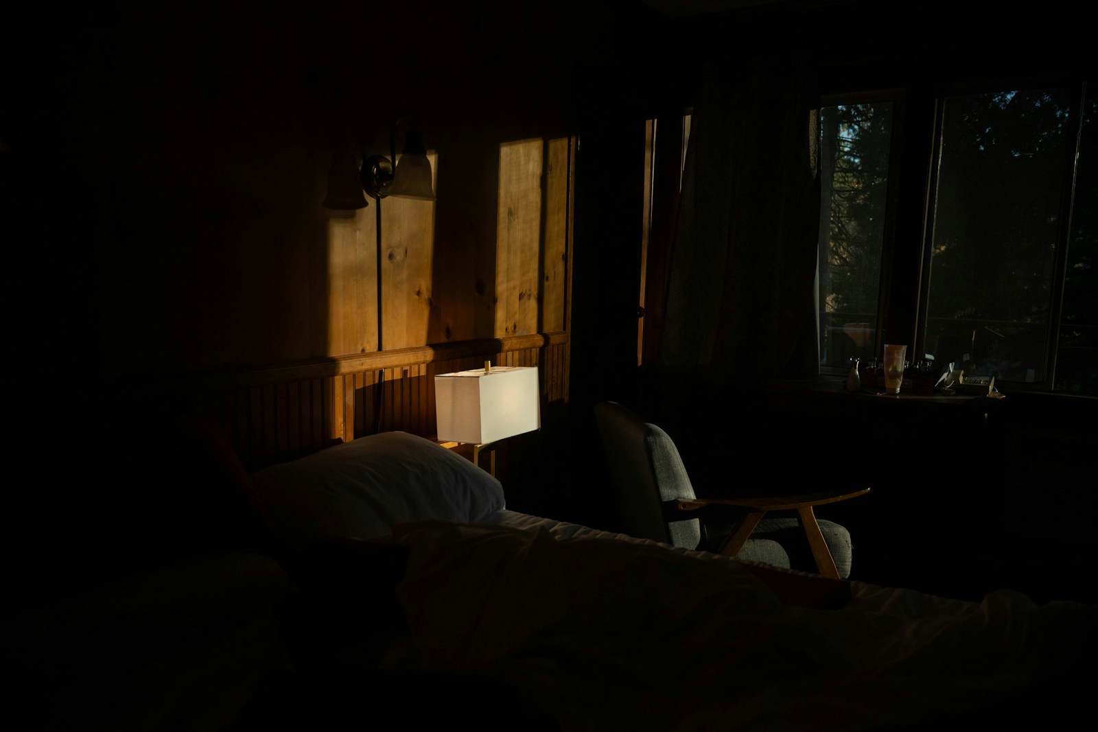 A dimly lit bedroom at night, where condensation and damp usually show up first